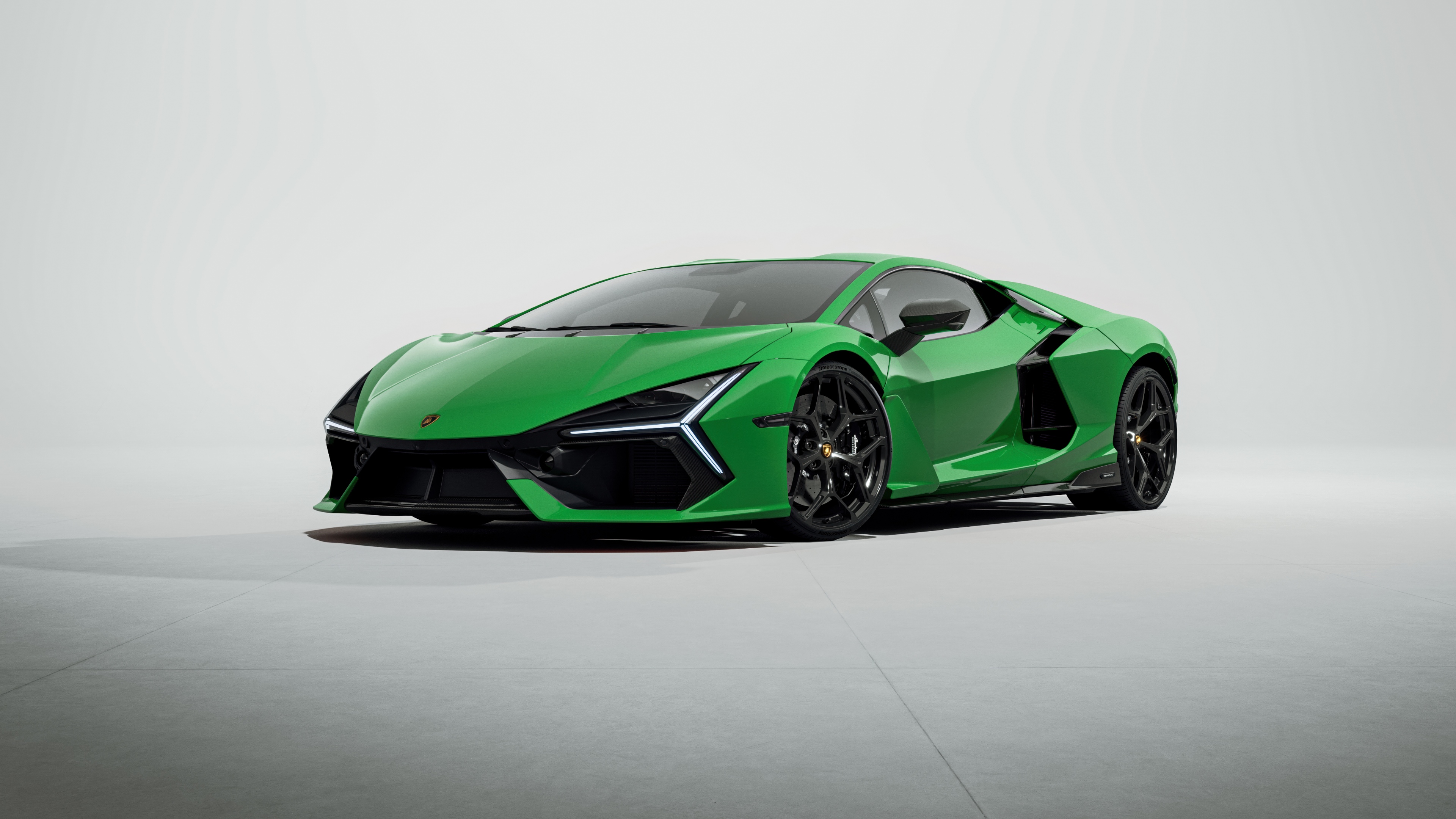 A detailed studio shot of the Lamborghini Revuelto super sports car isolated on a white background.