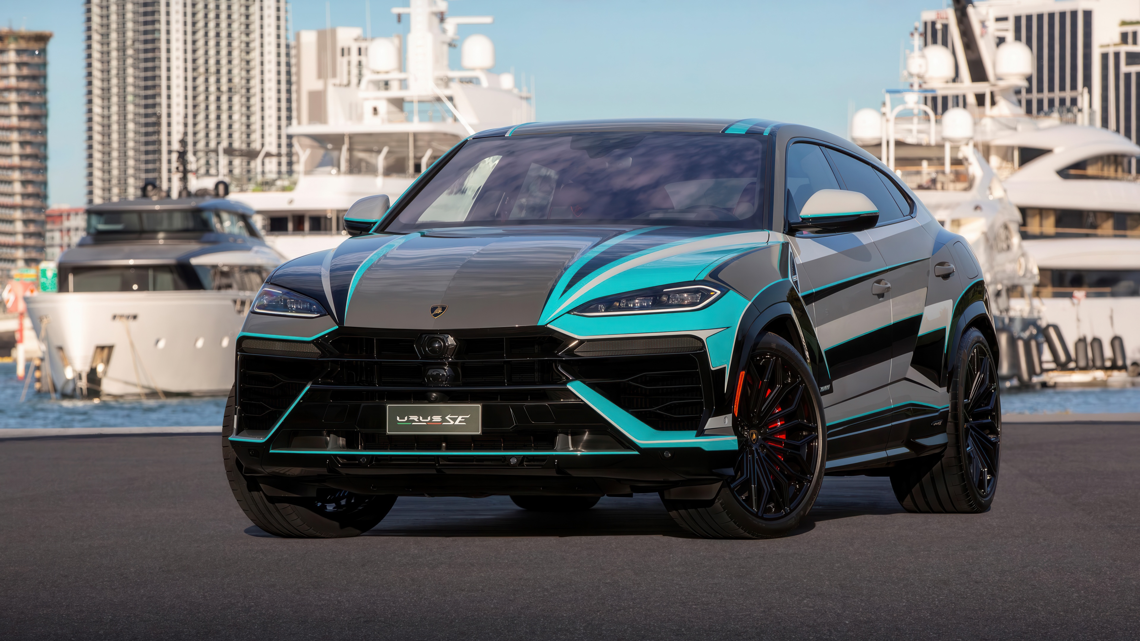 A luxury Lamborghini Urus SE plug-in hybrid SUV driving through the bright, sunny streets of Miami.