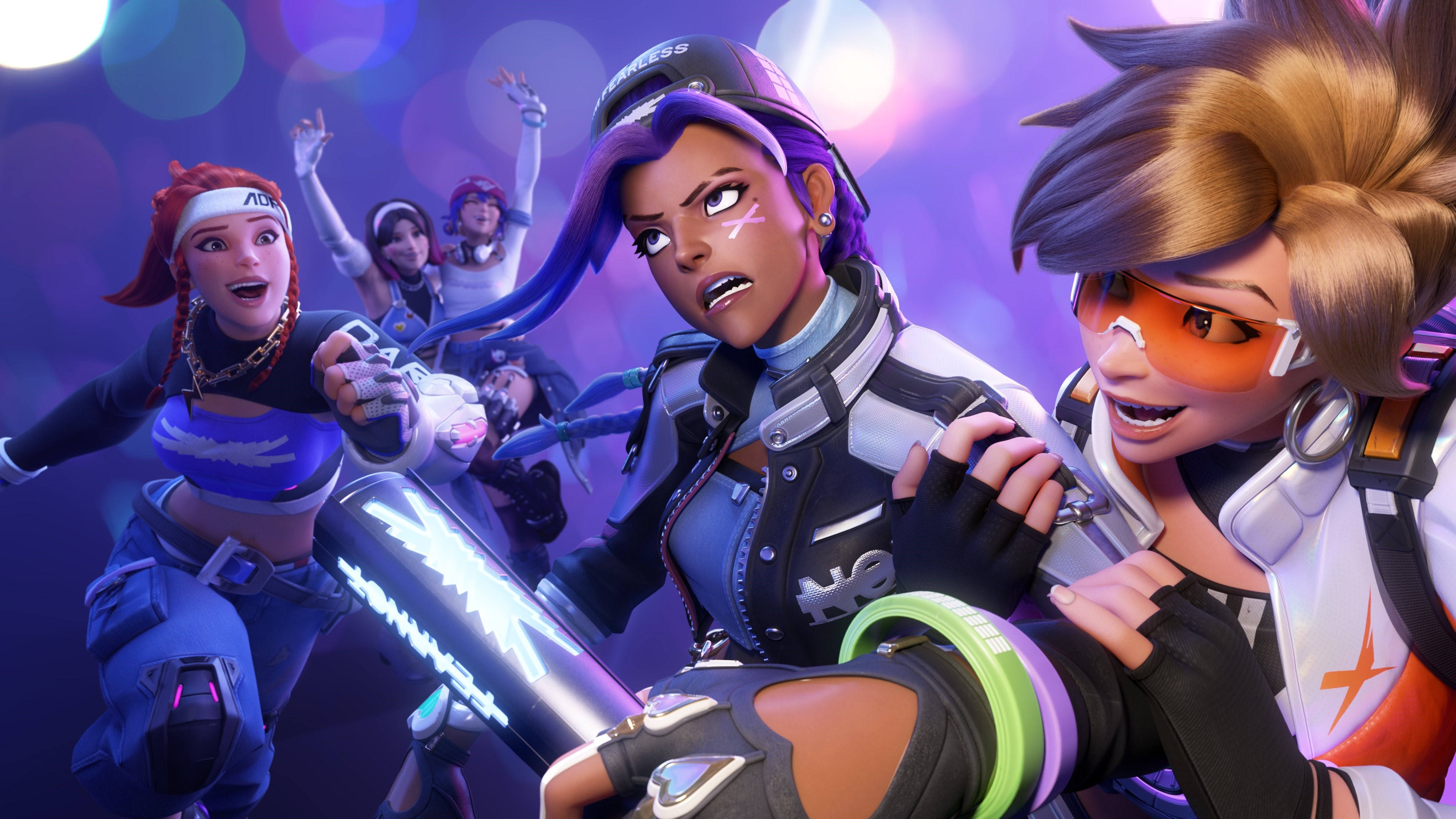 Members of the K-pop group Le Sserafim dressed as the Overwatch 2 characters Tracer, Sombra, and Brigitte.