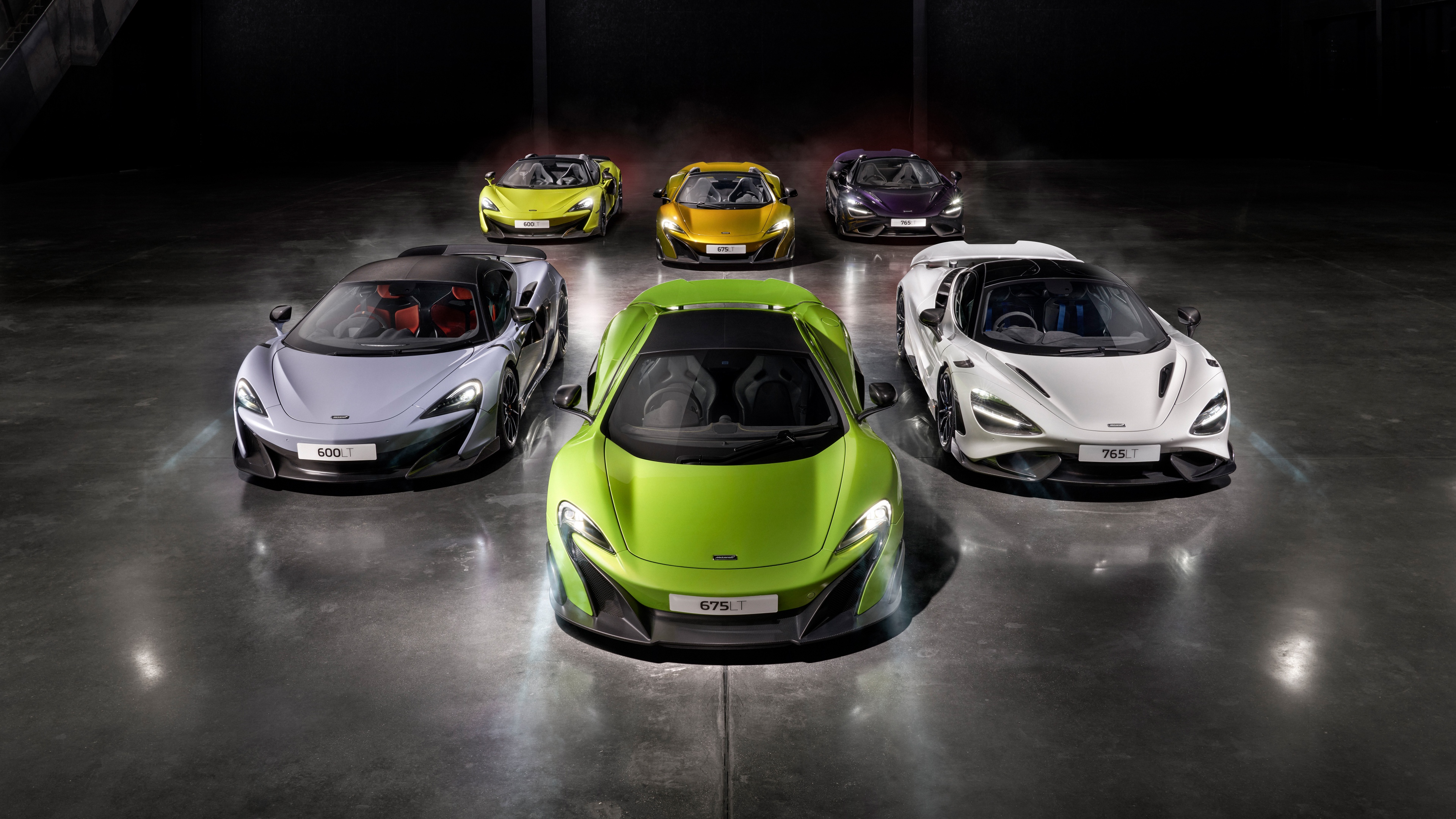 A high-resolution composition of three McLaren supercars: the 600LT, 675LT, and 765LT.