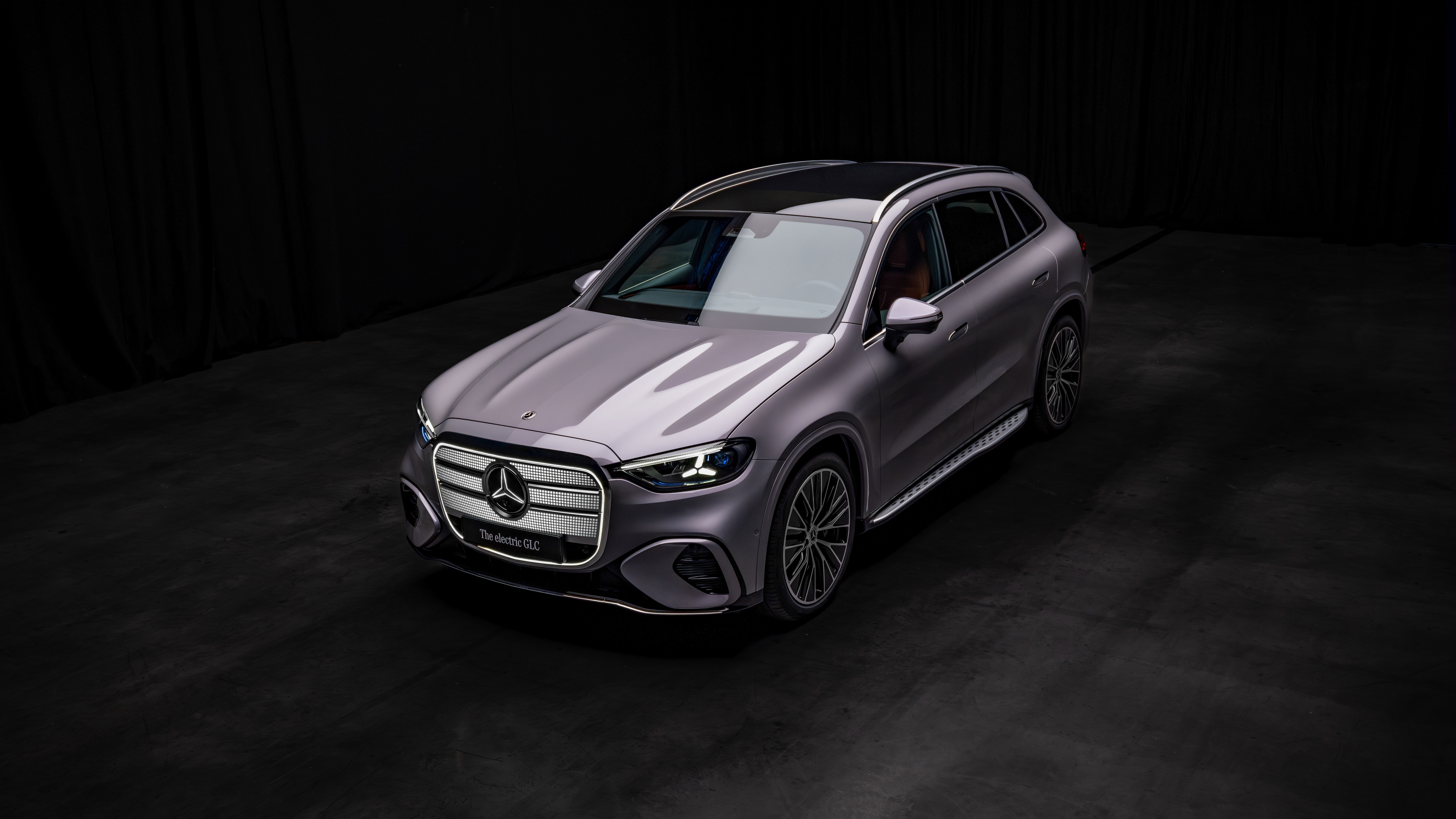 High-resolution 8K shot of a Mercedes-Benz GLC 400 luxury SUV against a dark, dramatic background.