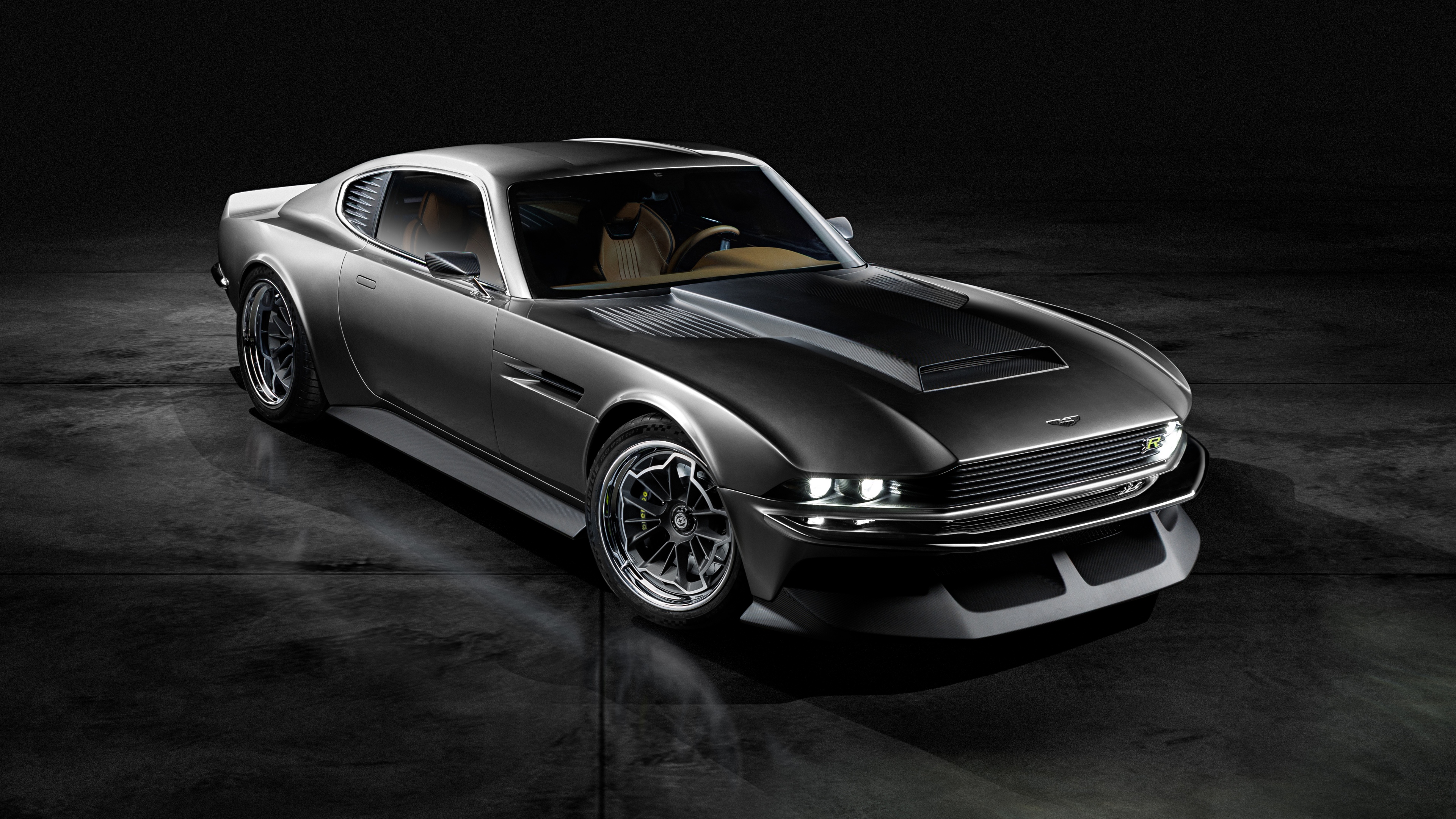 A 2025 Aston Martin DBS luxury car featuring a dark, cinematic aesthetic and a black background.