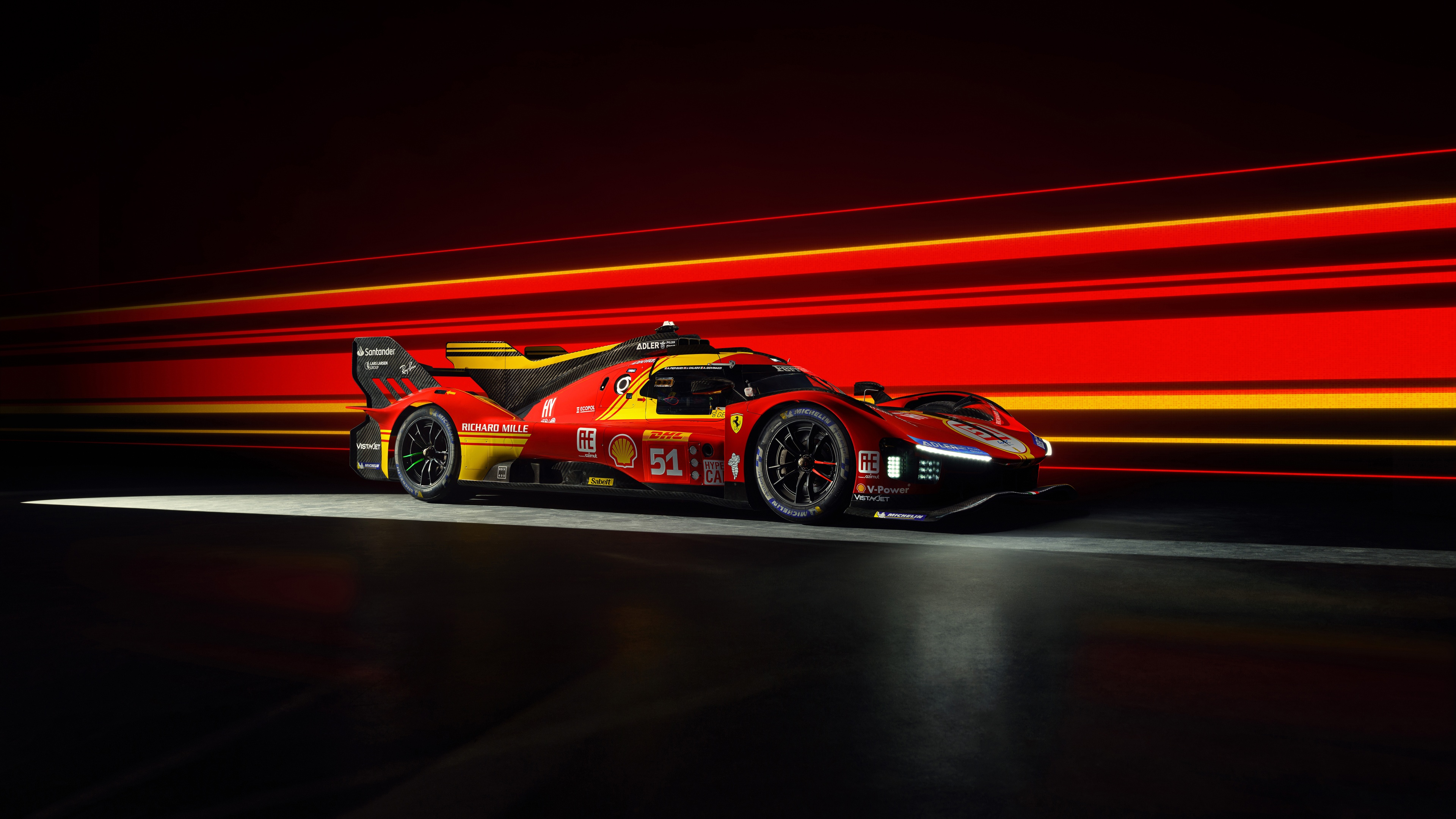 A Ferrari 499P Le Mans Hypercar driving through the night with glowing light trails and a dark, cinematic aesthetic.
