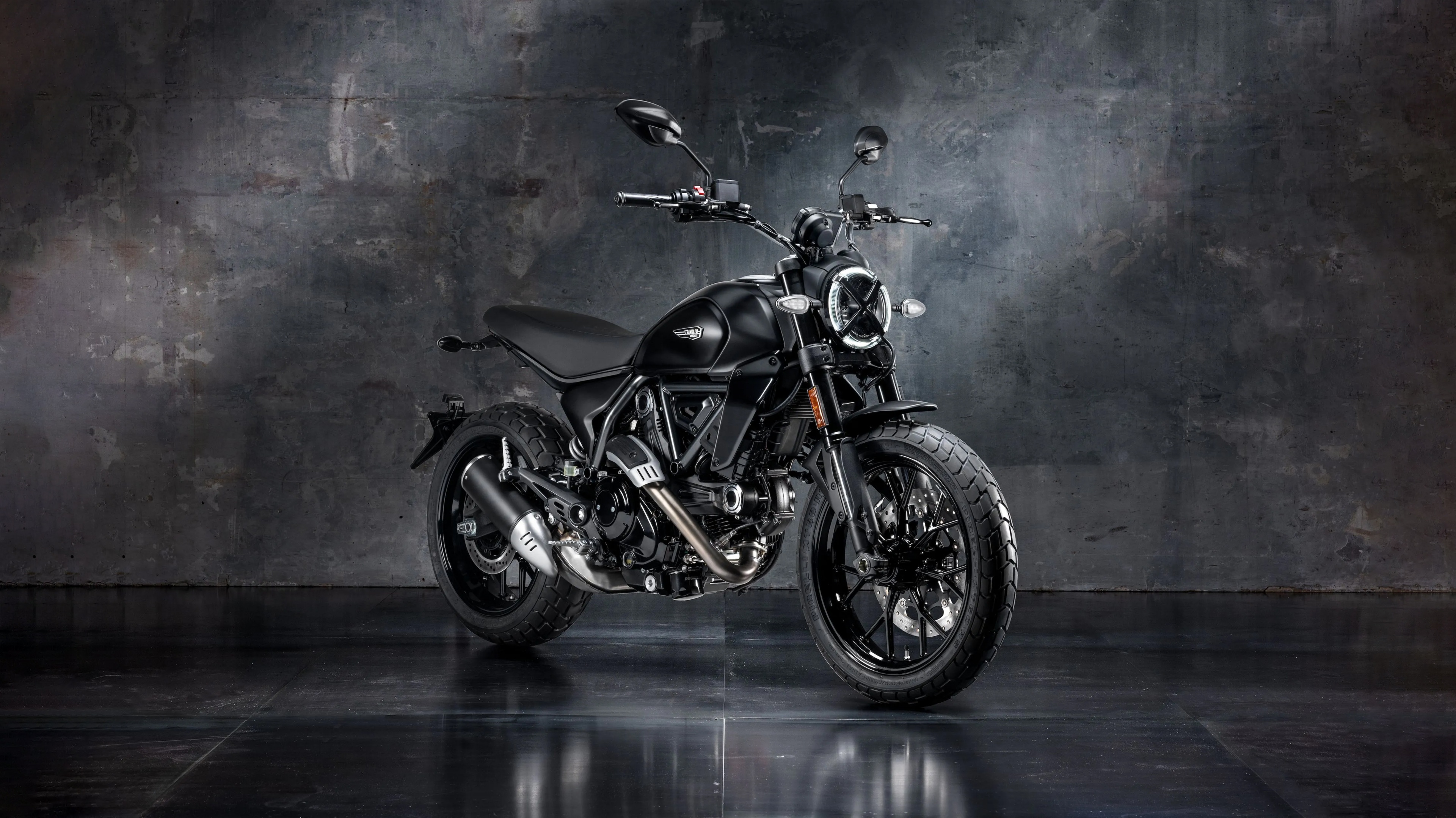 A sleek and polished 2025 cafe racer motorcycle featuring a neo-retro design with chrome and matte black accents.