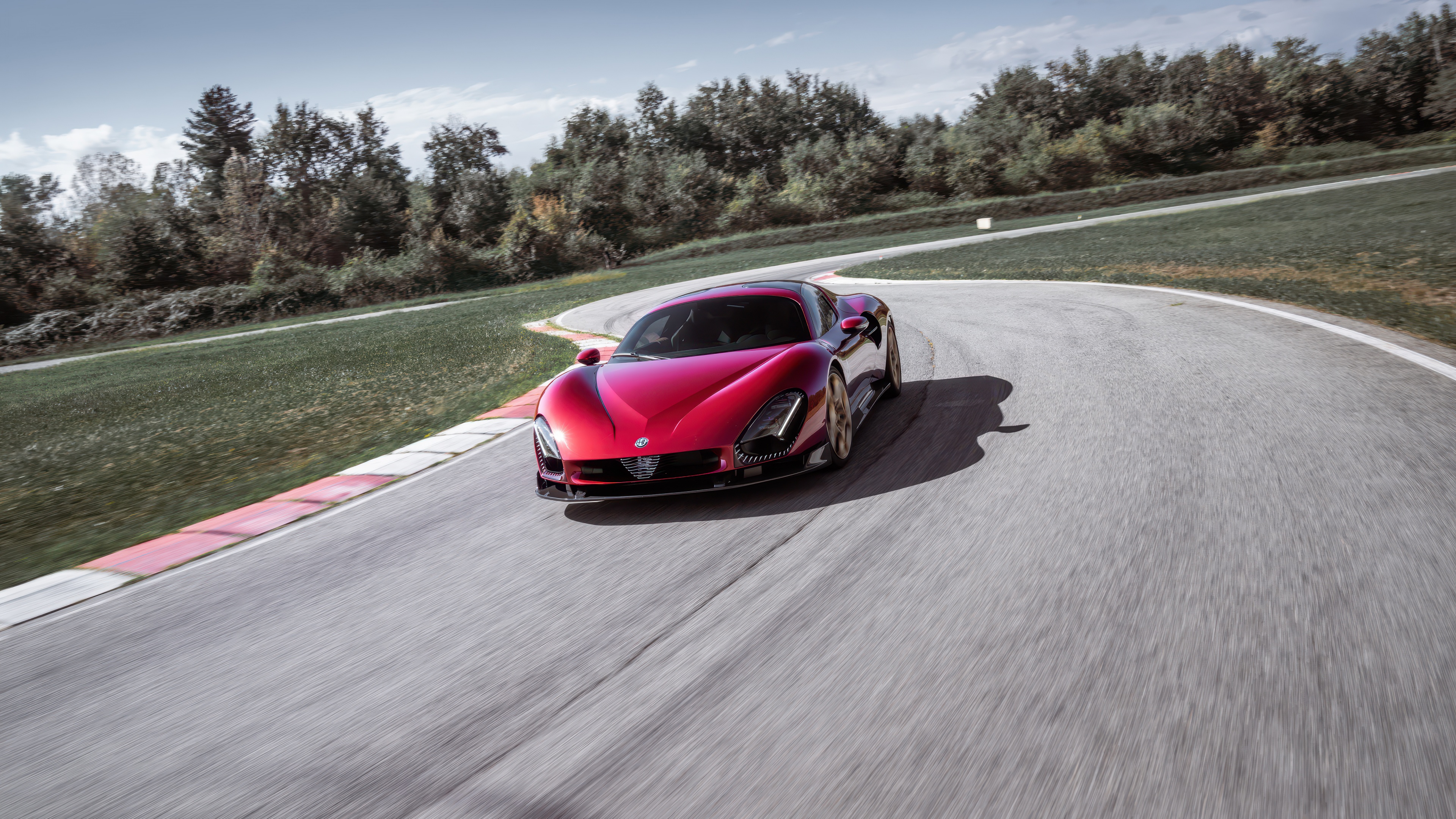 A vibrant red Alfa Romeo 33 Stradale speeding through a turn on a race track circuit.