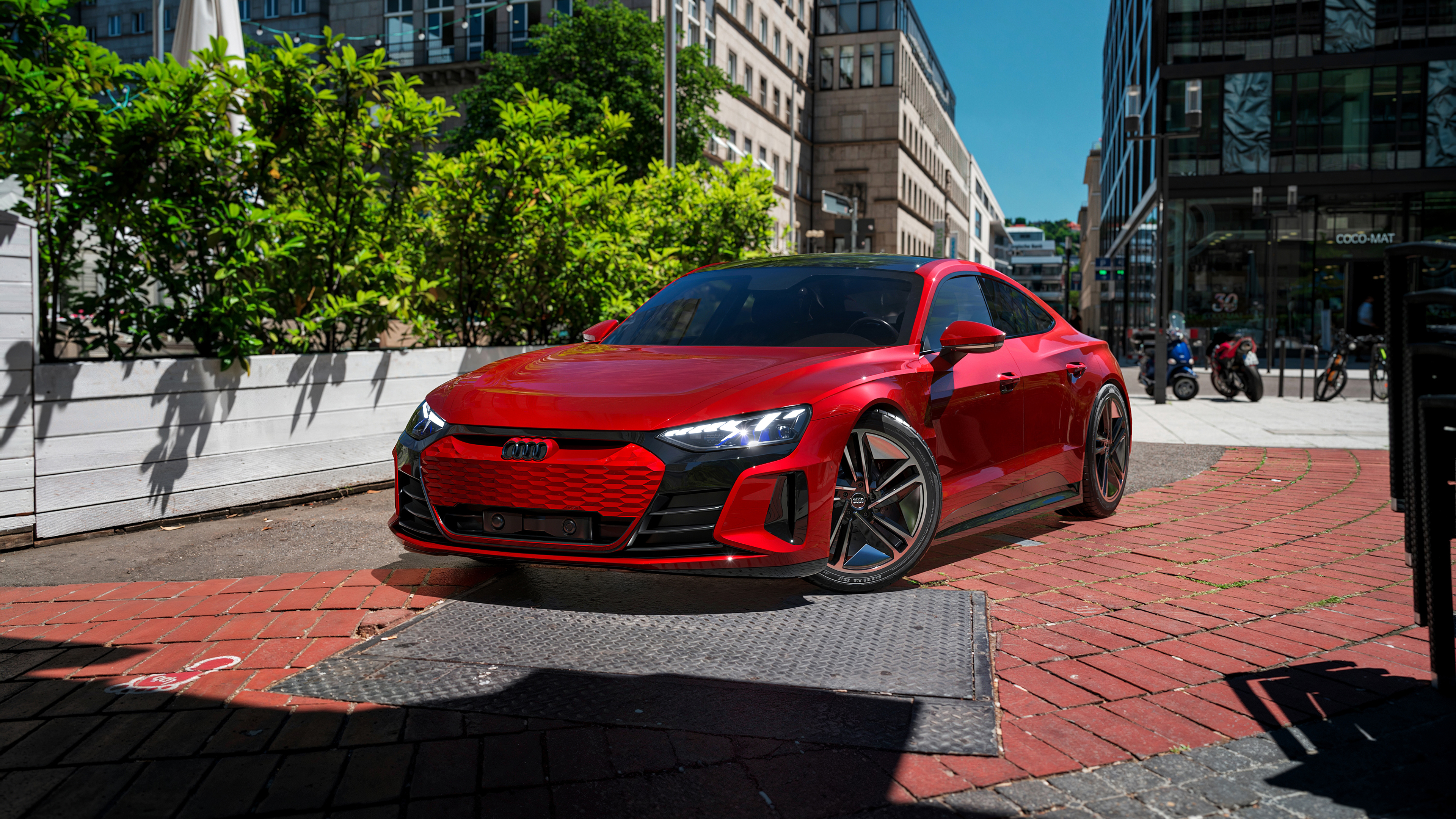 Red Audi RS e-tron GT luxury electric sports car driving through a modern city street.