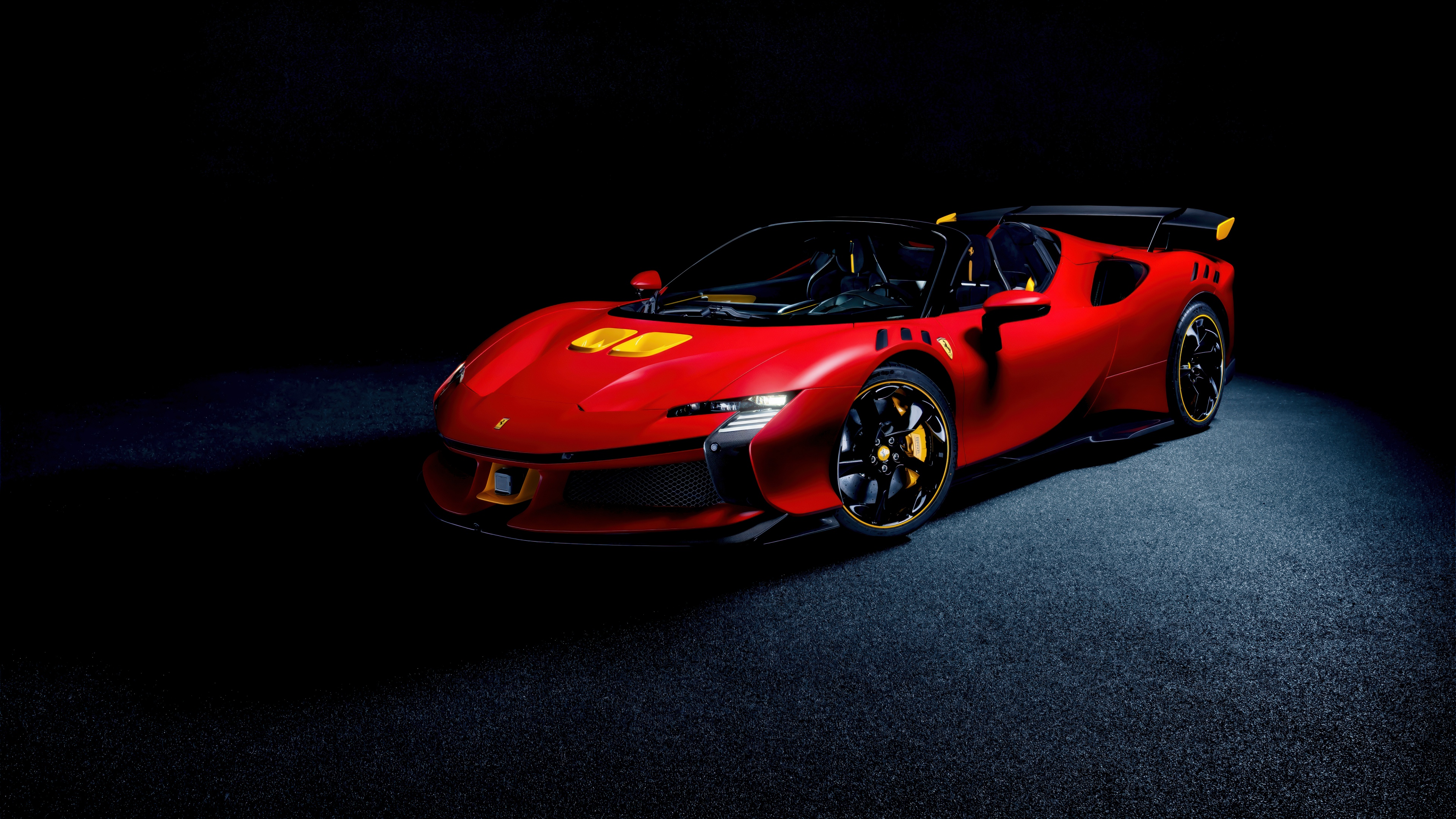 A sleek red Ferrari SF90 XX Spider automobile positioned against a deep, dark background highlighting its glossy red paint and aerodynamic design.