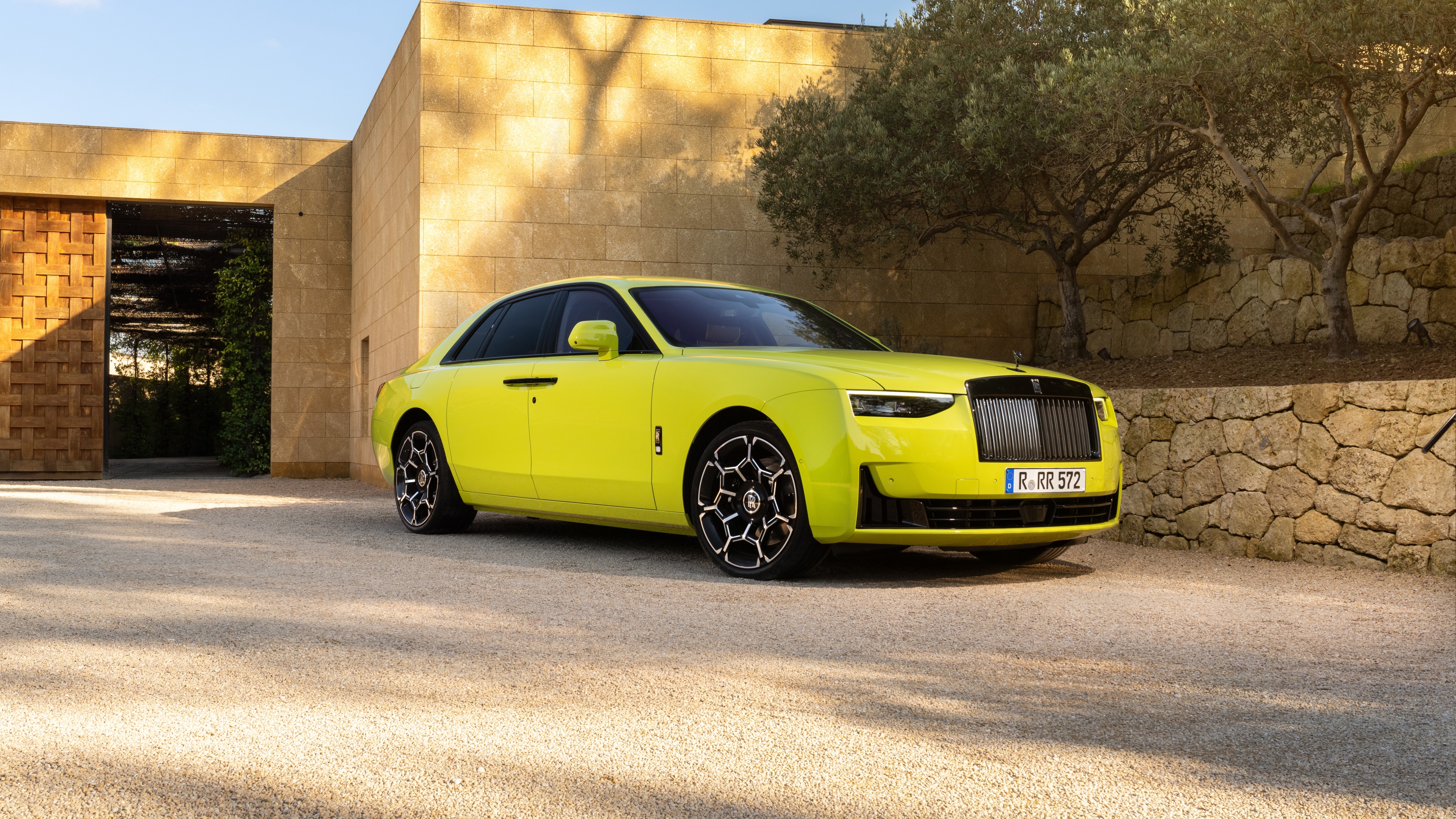 A high-resolution, detailed view of a luxurious Rolls-Royce Black Badge Ghost featuring a dark, polished finish.