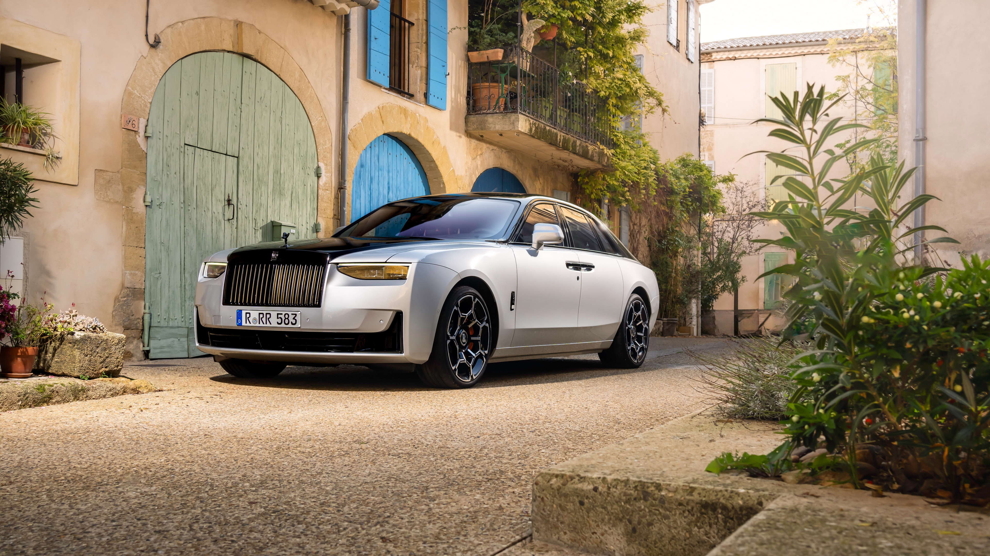 A high-detail, cinematic shot of a sleek Rolls-Royce Black Badge Ghost featuring a dark, luxurious aesthetic.