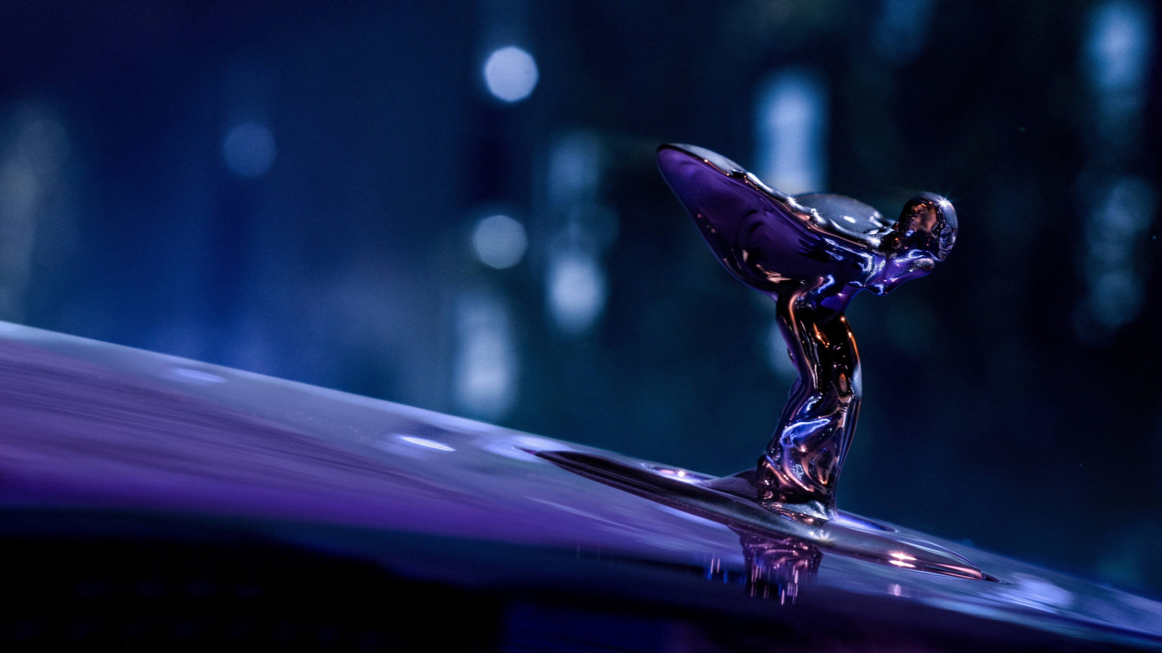 A luxury 2025 Rolls-Royce Black Badge Spectre car featuring a vibrant purple neon aesthetic and dark, moody lighting.