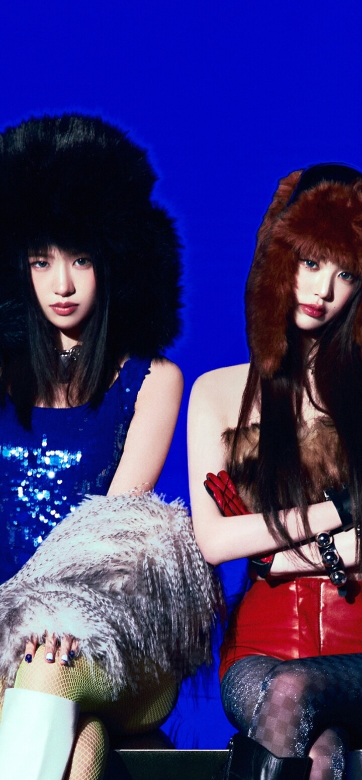 Members of the K-pop group IVE posing against a bright blue background