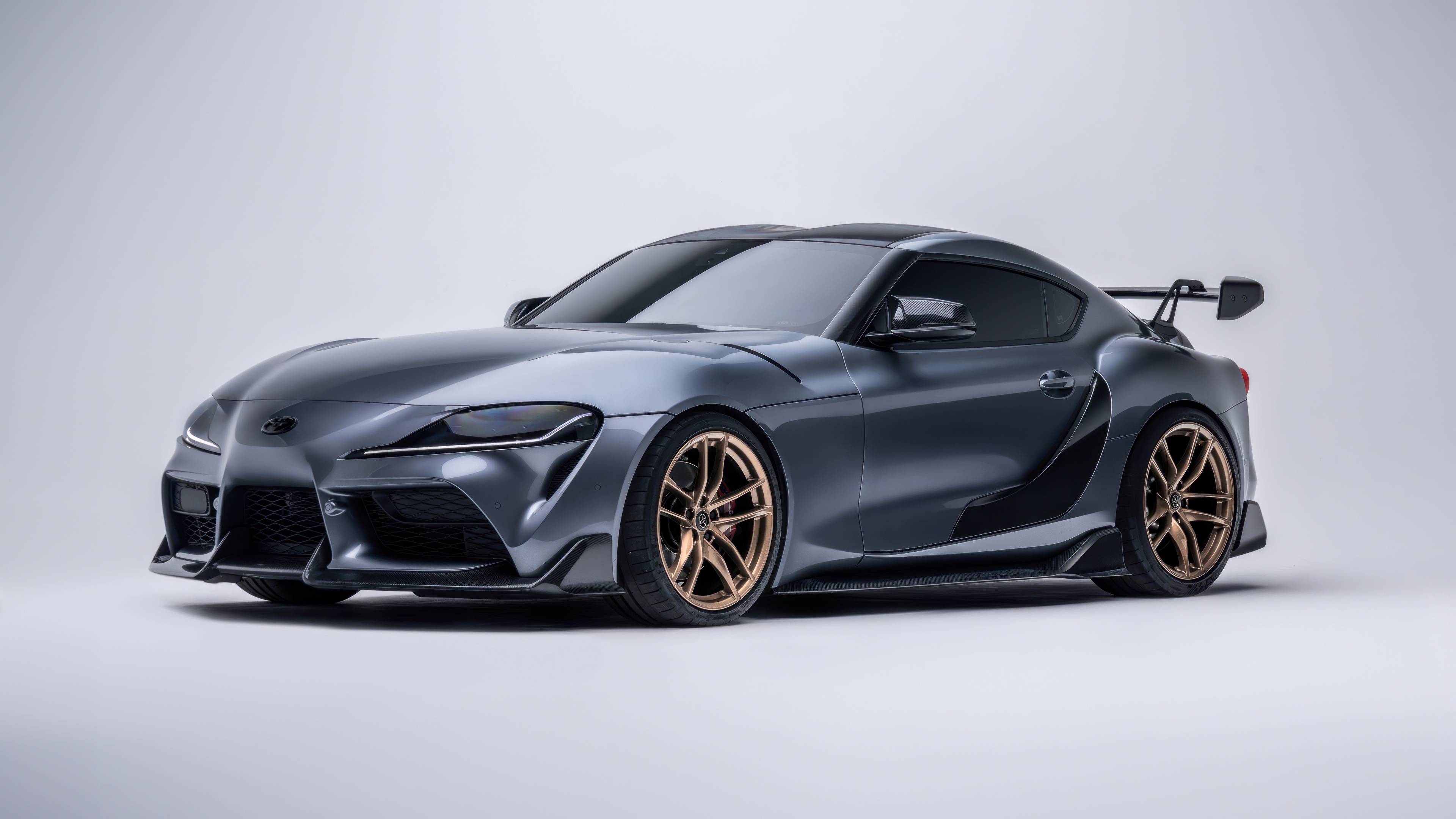 Detailed close-up of a Toyota GR Supra featuring carbon fiber textures and high-performance styling.
