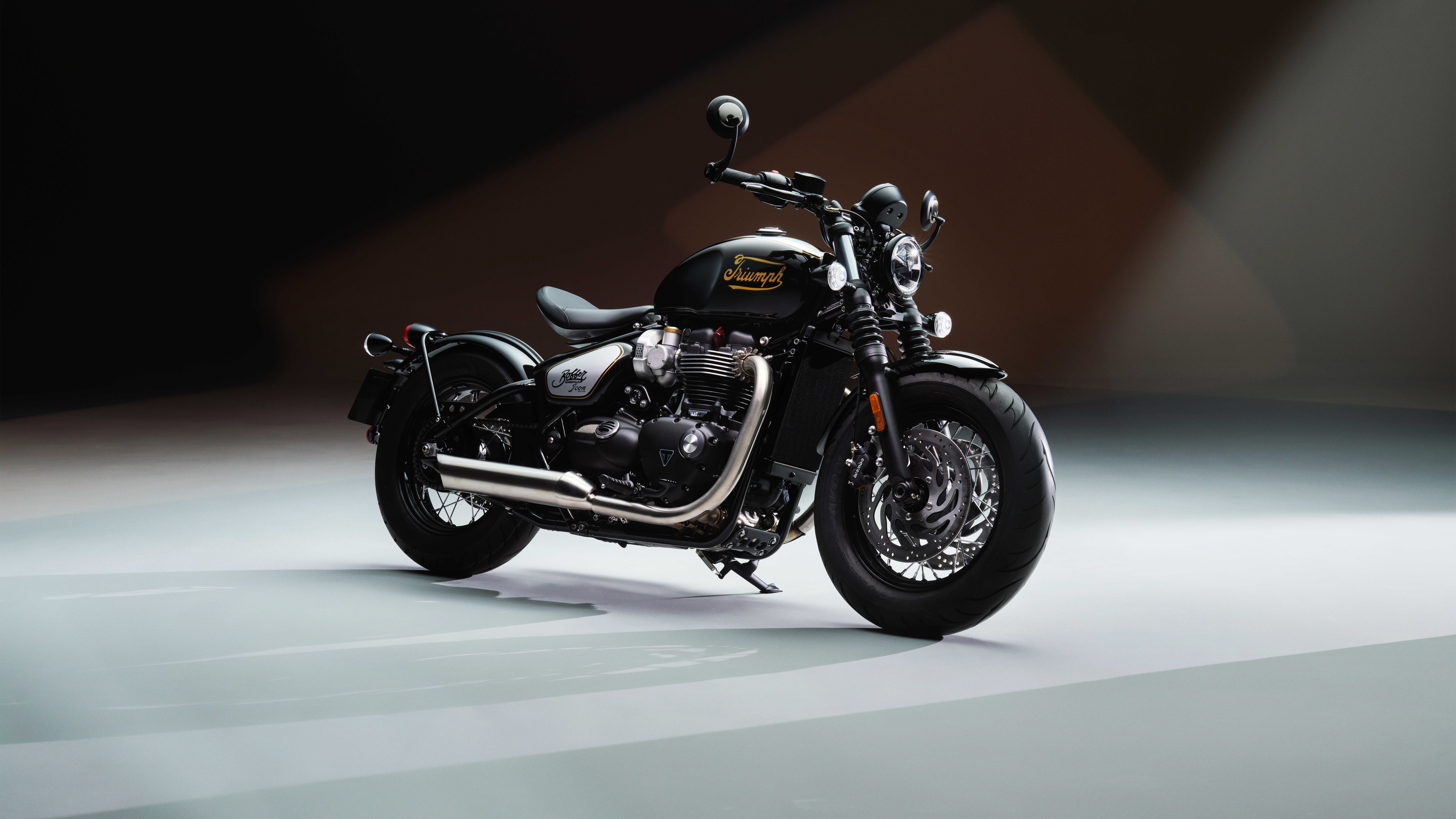 High-resolution cinematic shot of the Triumph Bonneville Bobber TFC motorcycle featuring polished chrome and premium blacked-out components.