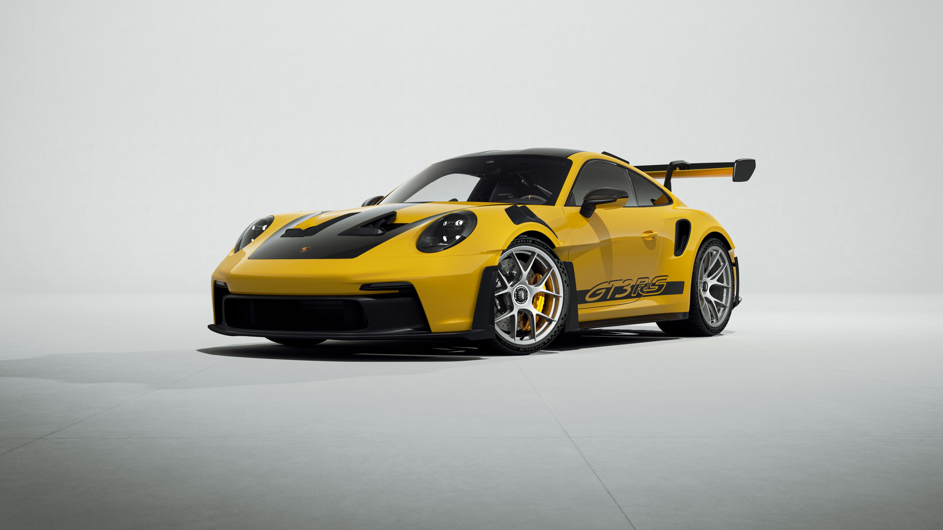 A high-detail, vibrant yellow Porsche 911 GT3 RS showcasing its aerodynamic design.