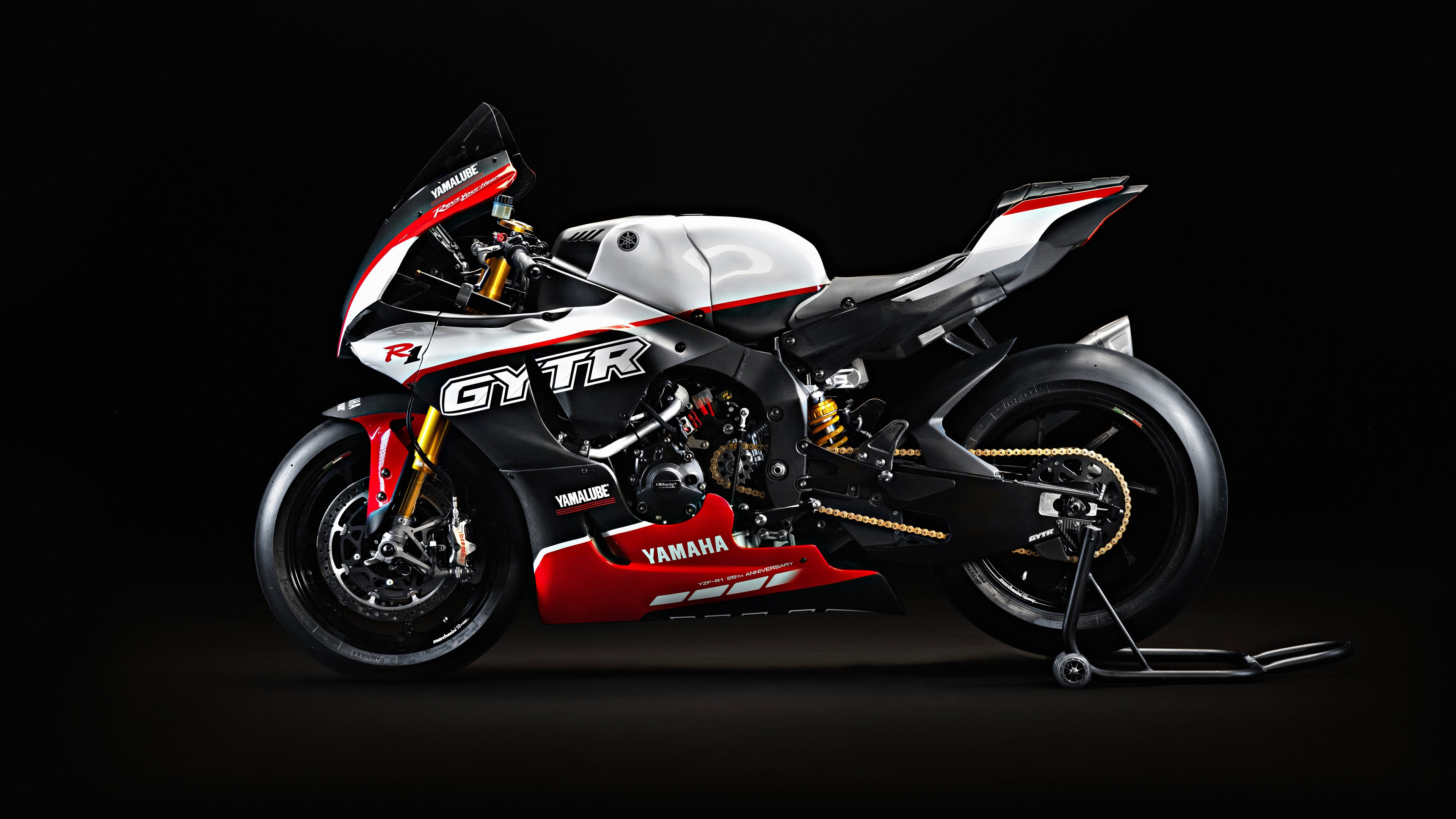 A detailed 8K shot of the 2023 Yamaha R1 GYTR Pro motorcycle featuring anniversary branding against a solid black background.
