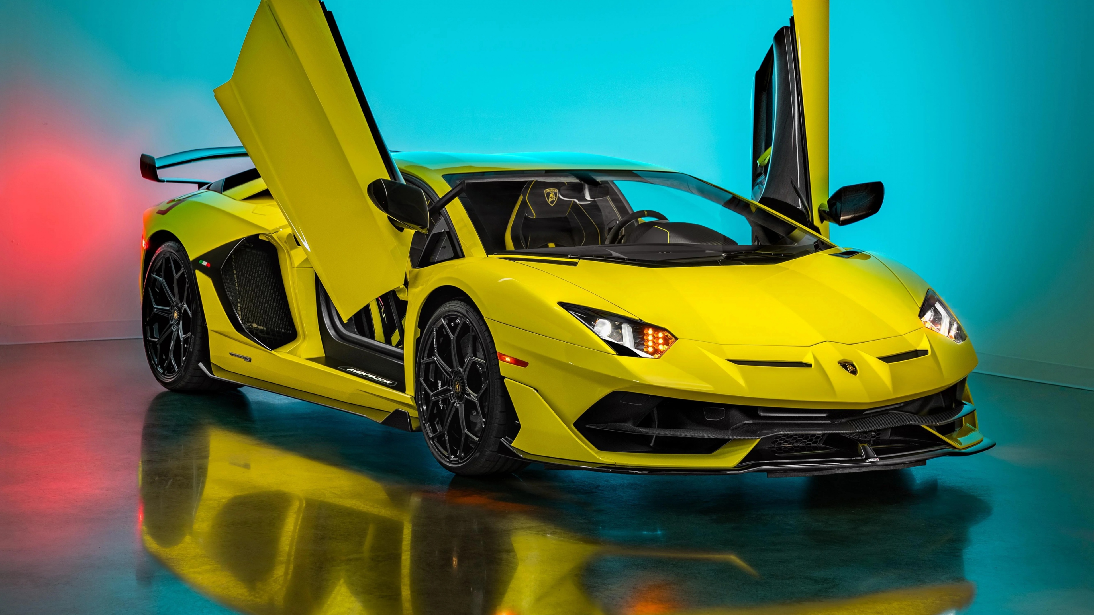 A vibrant yellow Lamborghini Aventador SVJ supercar captured in a vertical orientation.