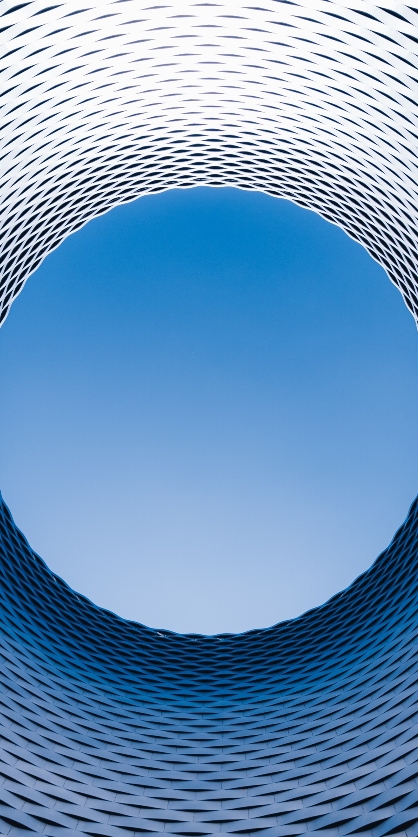 An aerial drone perspective of the modern spiral architecture of the Basel exhibition center in Switzerland.