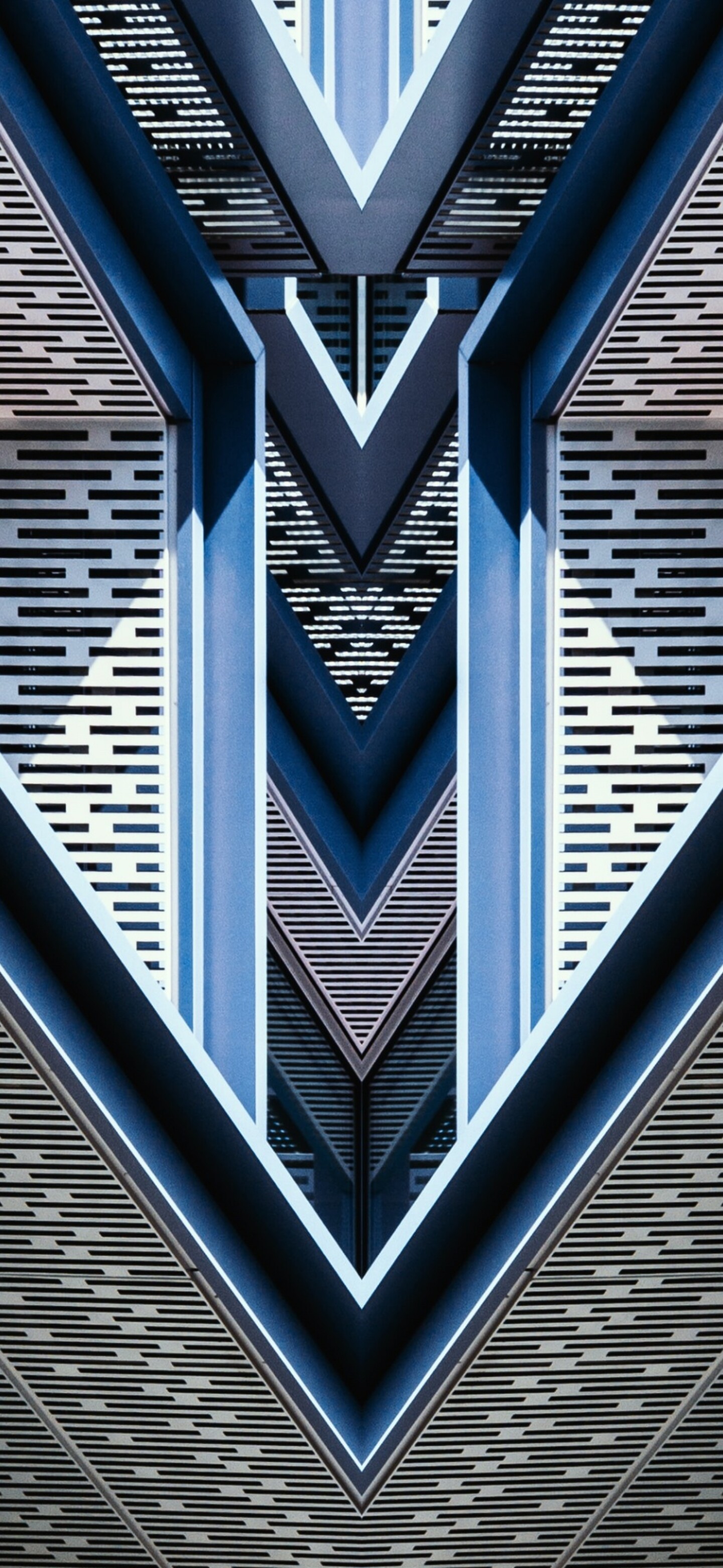 Close-up of a symmetrical blue building with intricate geometric patterns.