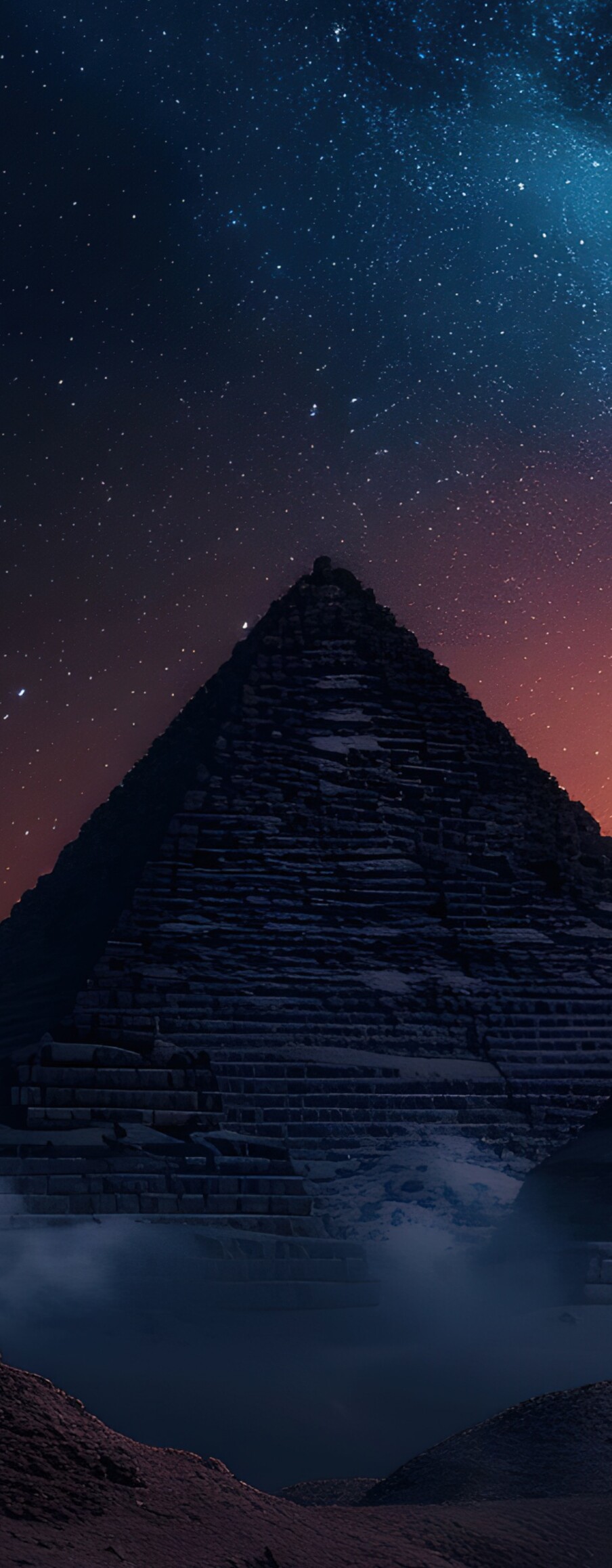 The Great Pyramid of Giza under a vibrant Milky Way galaxy and starry night sky in Egypt.