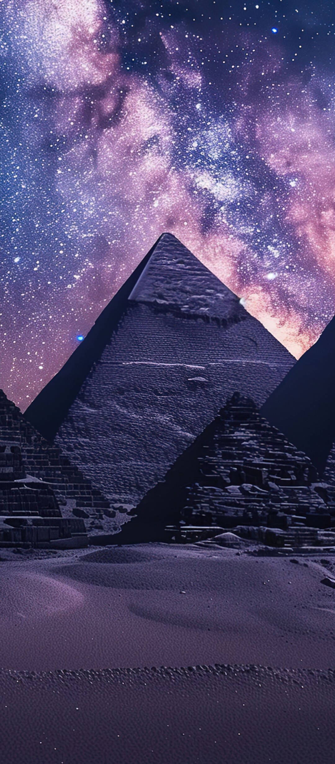 The Great Pyramids of Giza under a brilliant Milky Way galaxy and starry night sky.