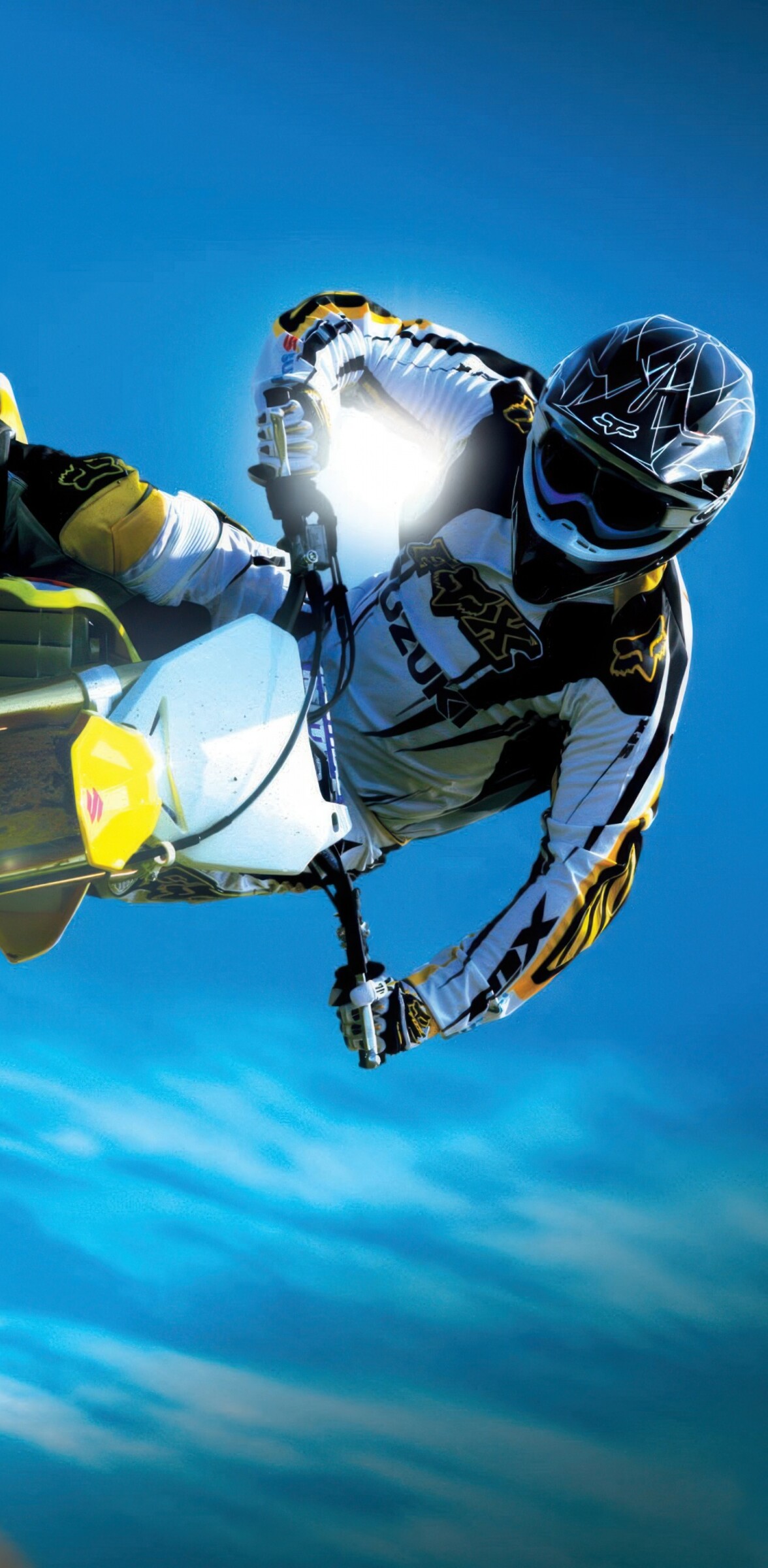 A motocross rider performing an extreme aerial jump on a dirt bike during a stunt competition.