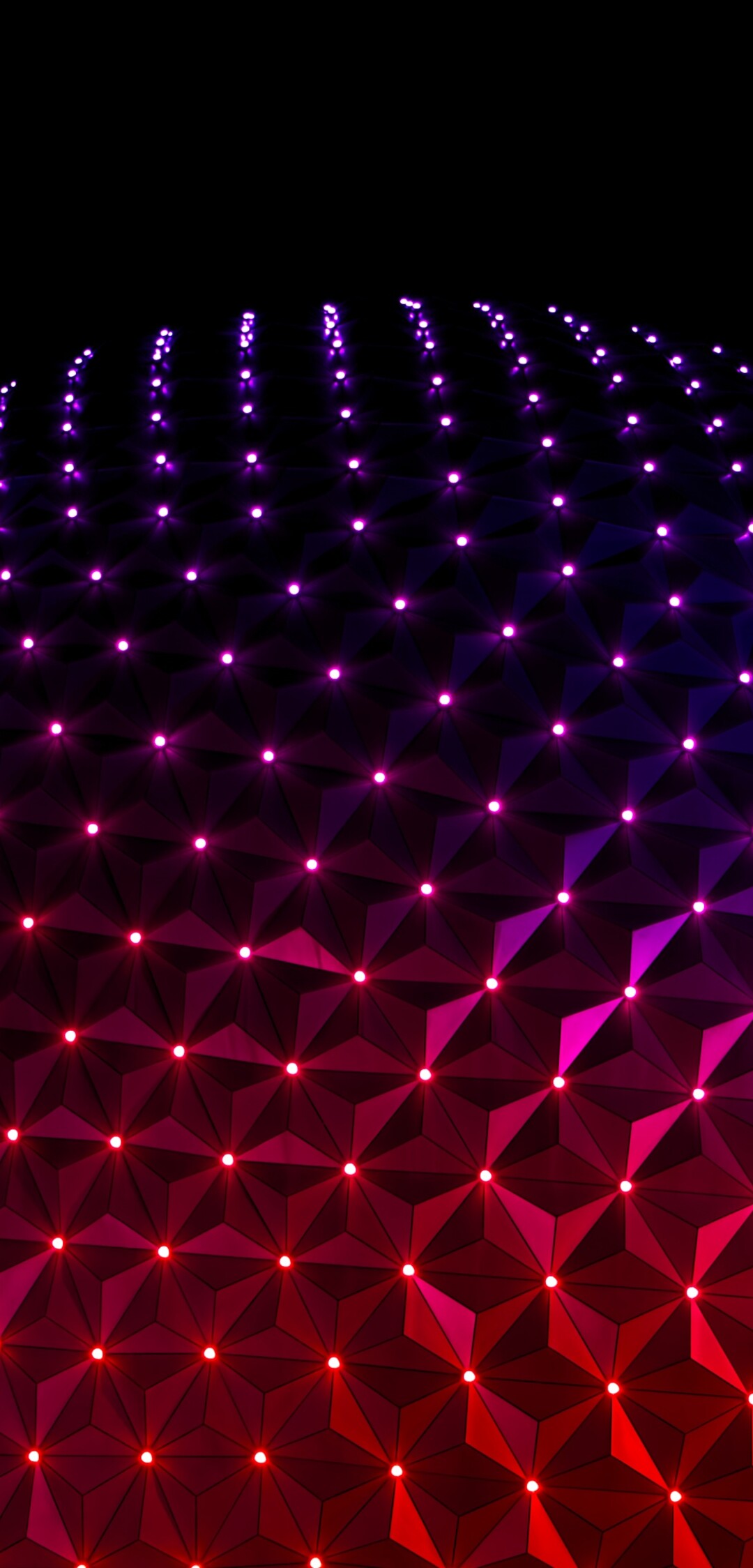 The illuminated Spaceship Earth structure at Epcot, Walt Disney World, at night.