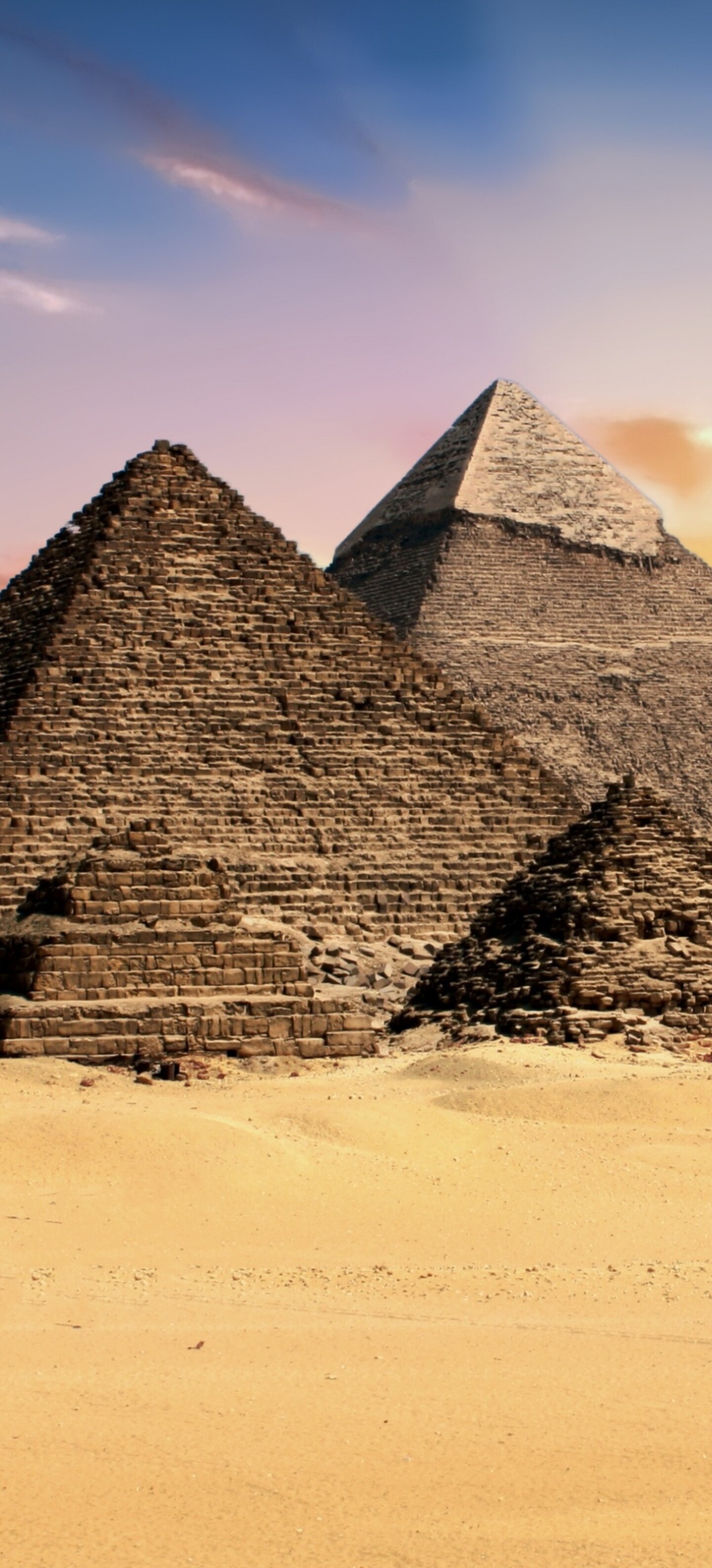 A scenic view of the Great Pyramids of Giza during a golden sunset in Egypt.