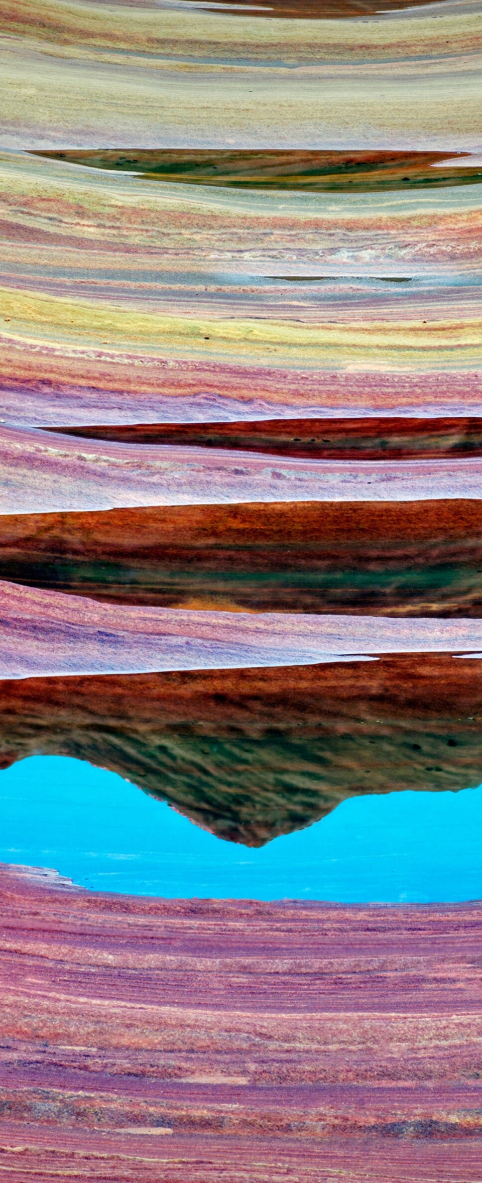 Vibrant orange and red swirling sandstone rock formations of The Wave in Arizona.
