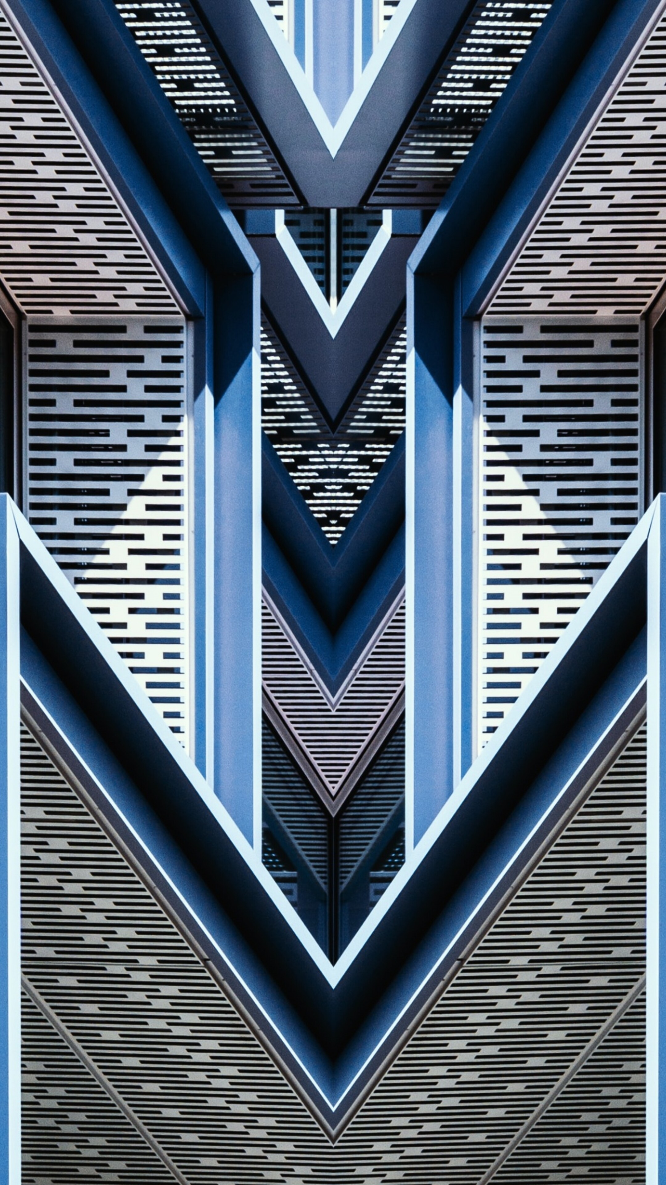 Close-up of a symmetrical blue building with intricate geometric patterns.
