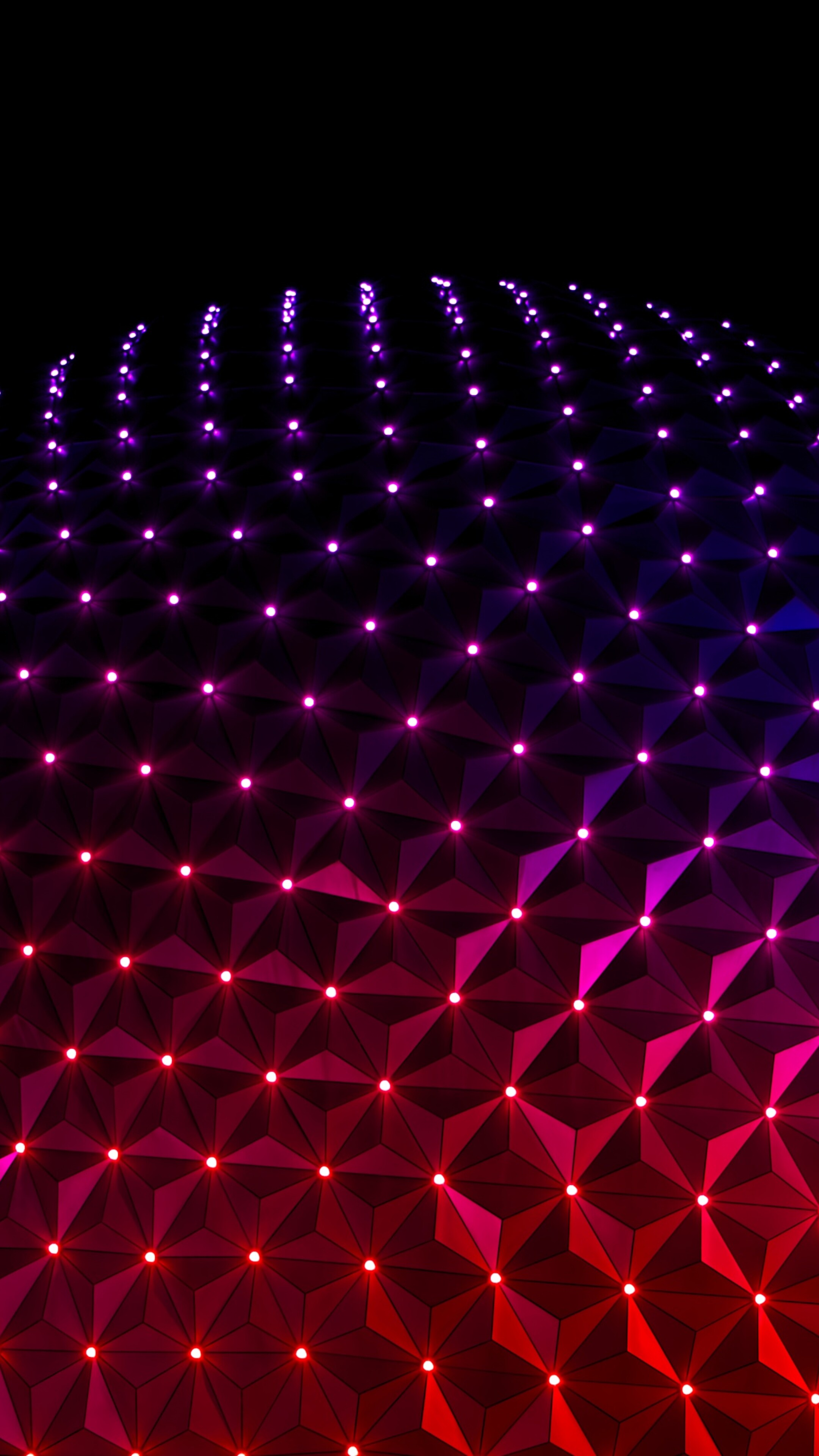 The illuminated Spaceship Earth structure at Epcot, Walt Disney World, at night.