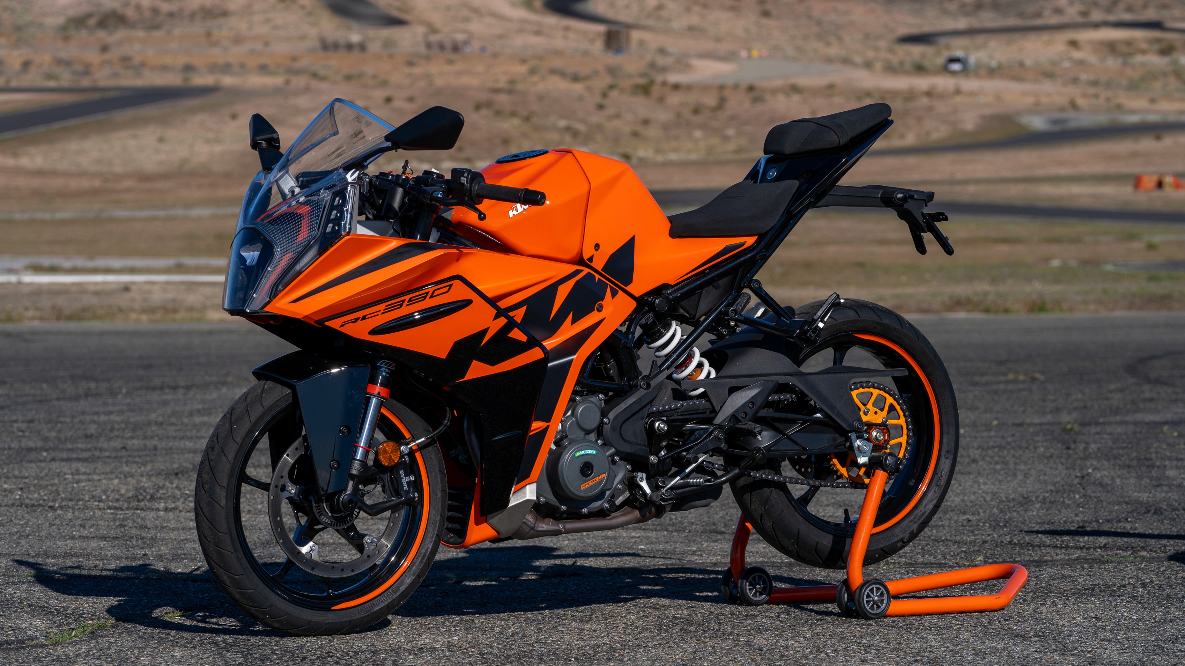 A high-detail shot of a 2022 KTM RC 390 sportbike featuring its aerodynamic frame and signature KTM racing colors.