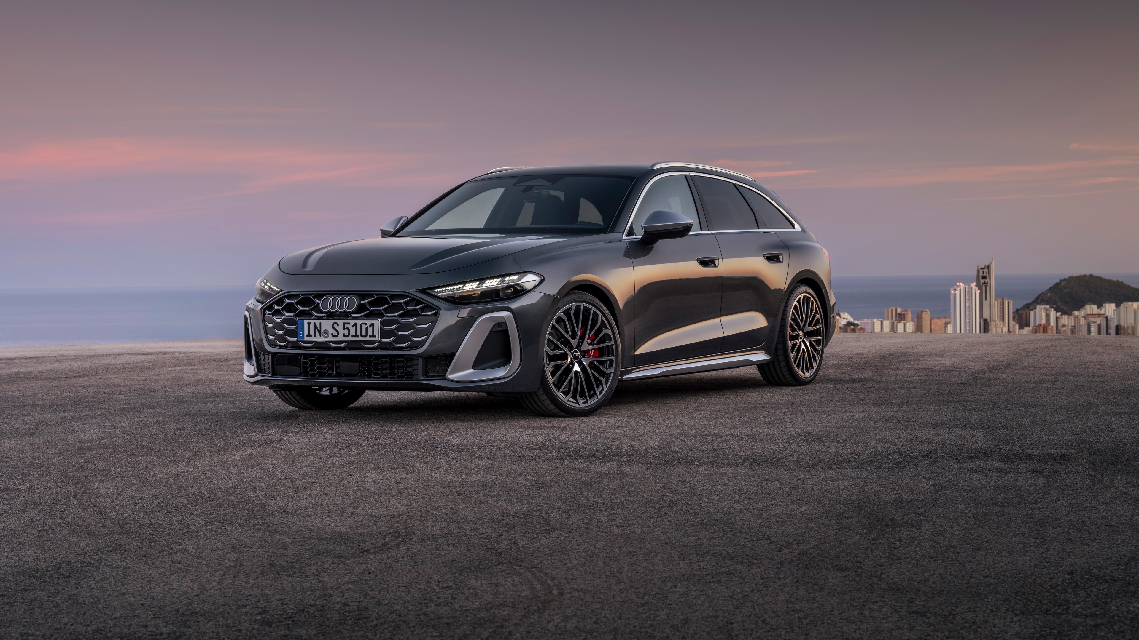 A detailed, high-resolution view of a 2024 Audi S5 Avant TFSI quattro, showcasing its sleek metallic finish and modern automotive styling.