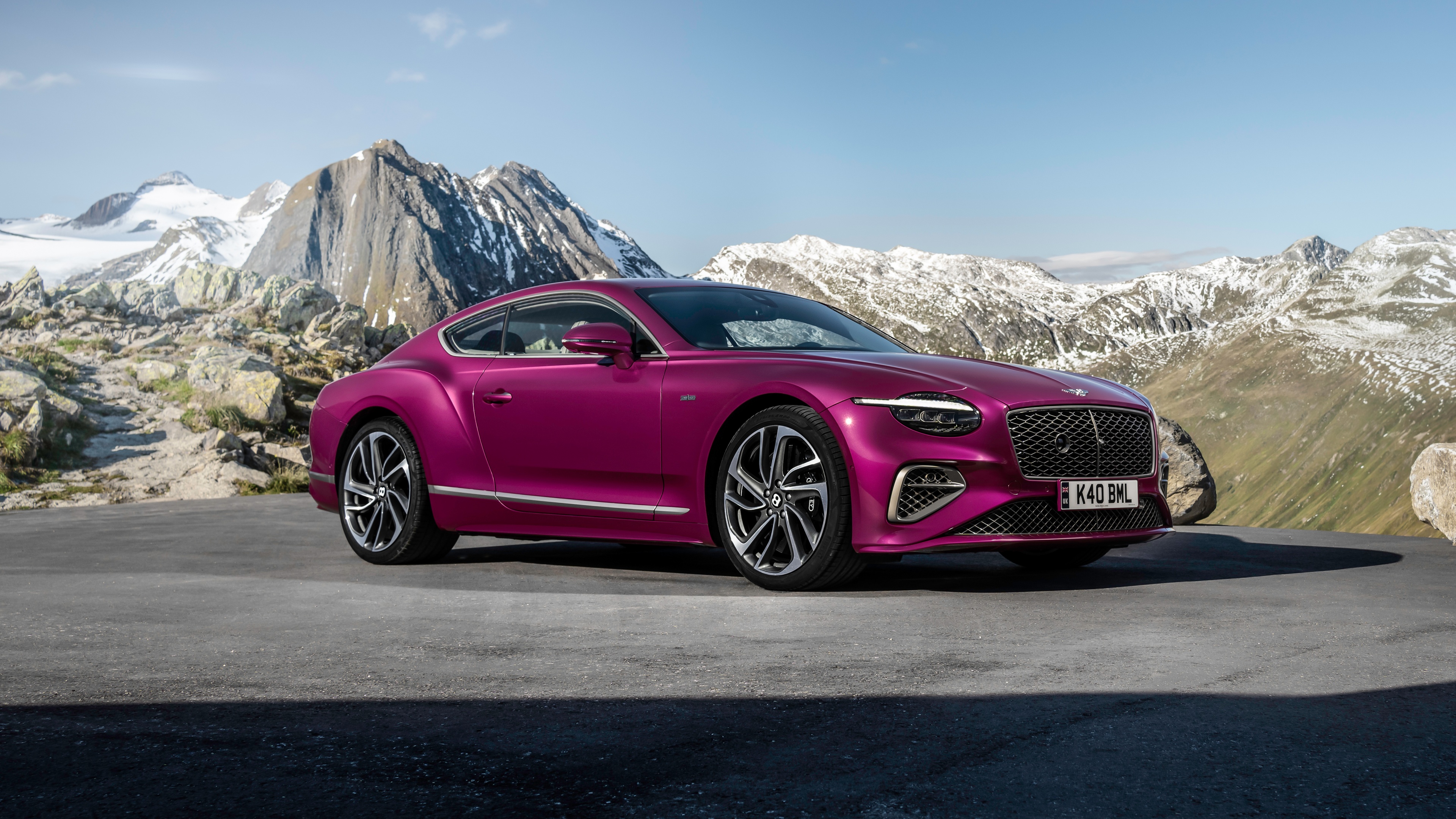 A luxury 2024 Bentley Continental GT Speed car with a striking purple color theme parked in an outdoor setting.