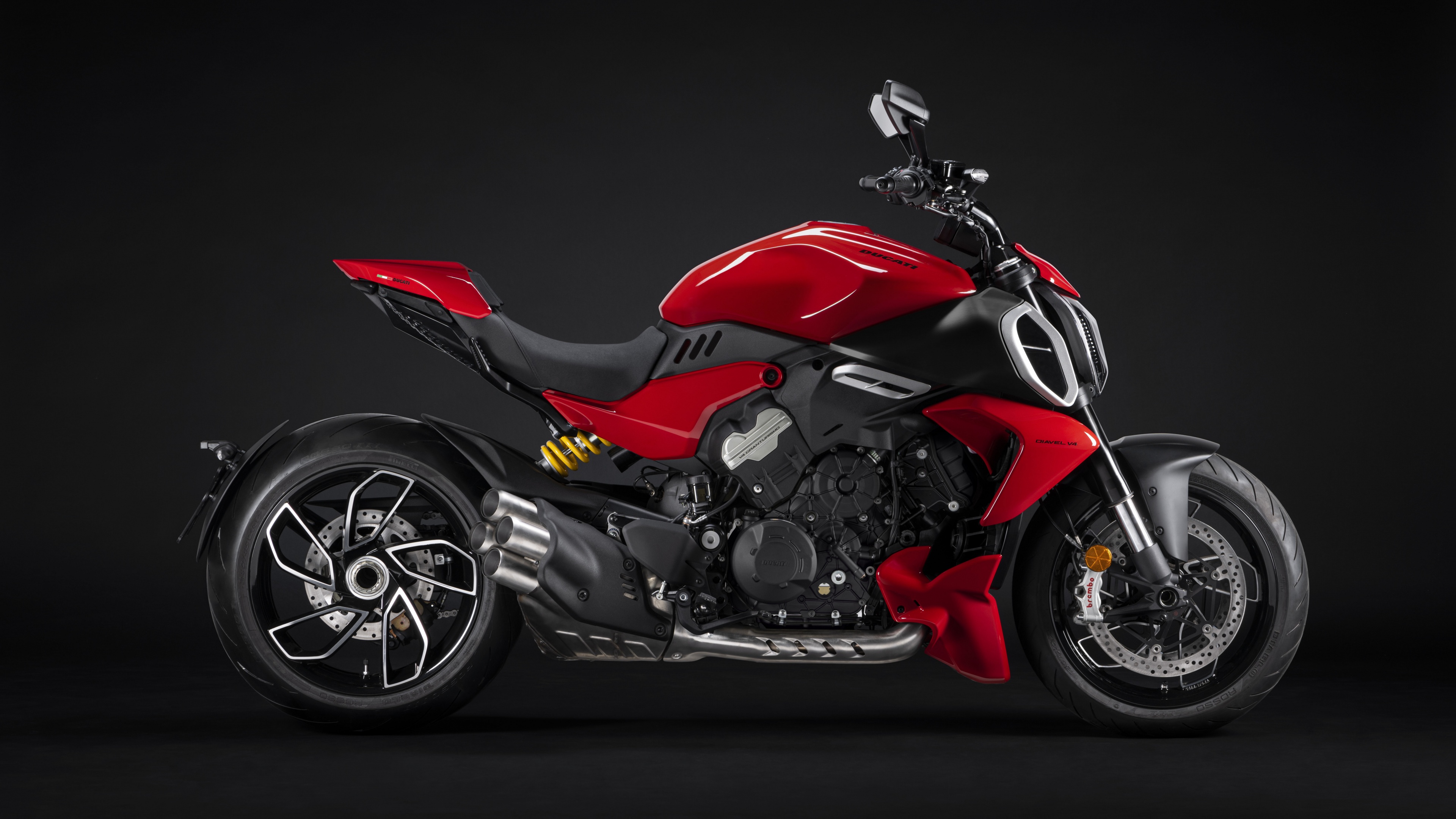 A 2023 Ducati Diavel V4 muscle cruiser motorcycle presented in high detail against a dramatic dark background.