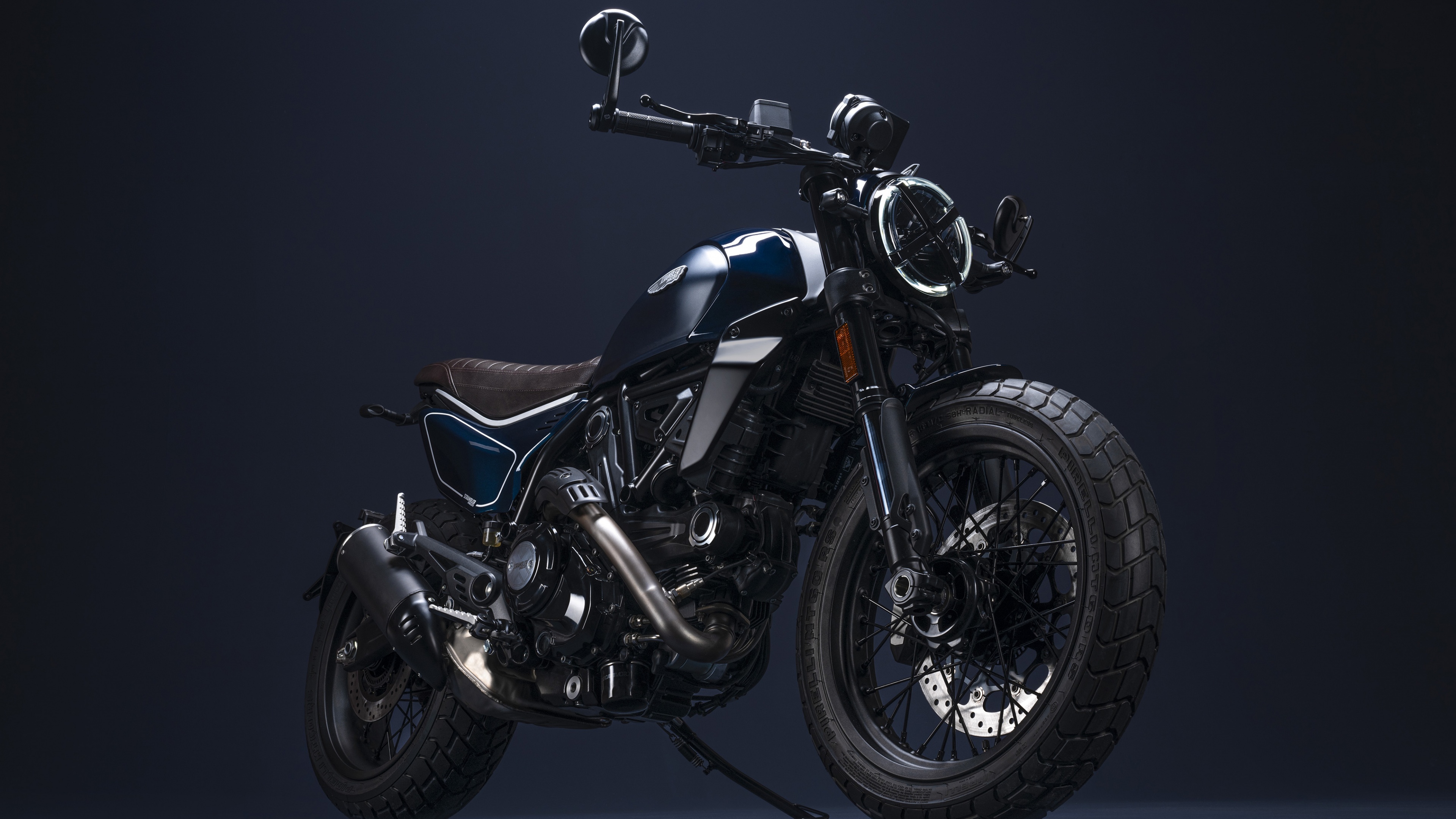 A sleek 2023 Ducati Scrambler Nightshift motorcycle positioned against a dark, minimalist background.