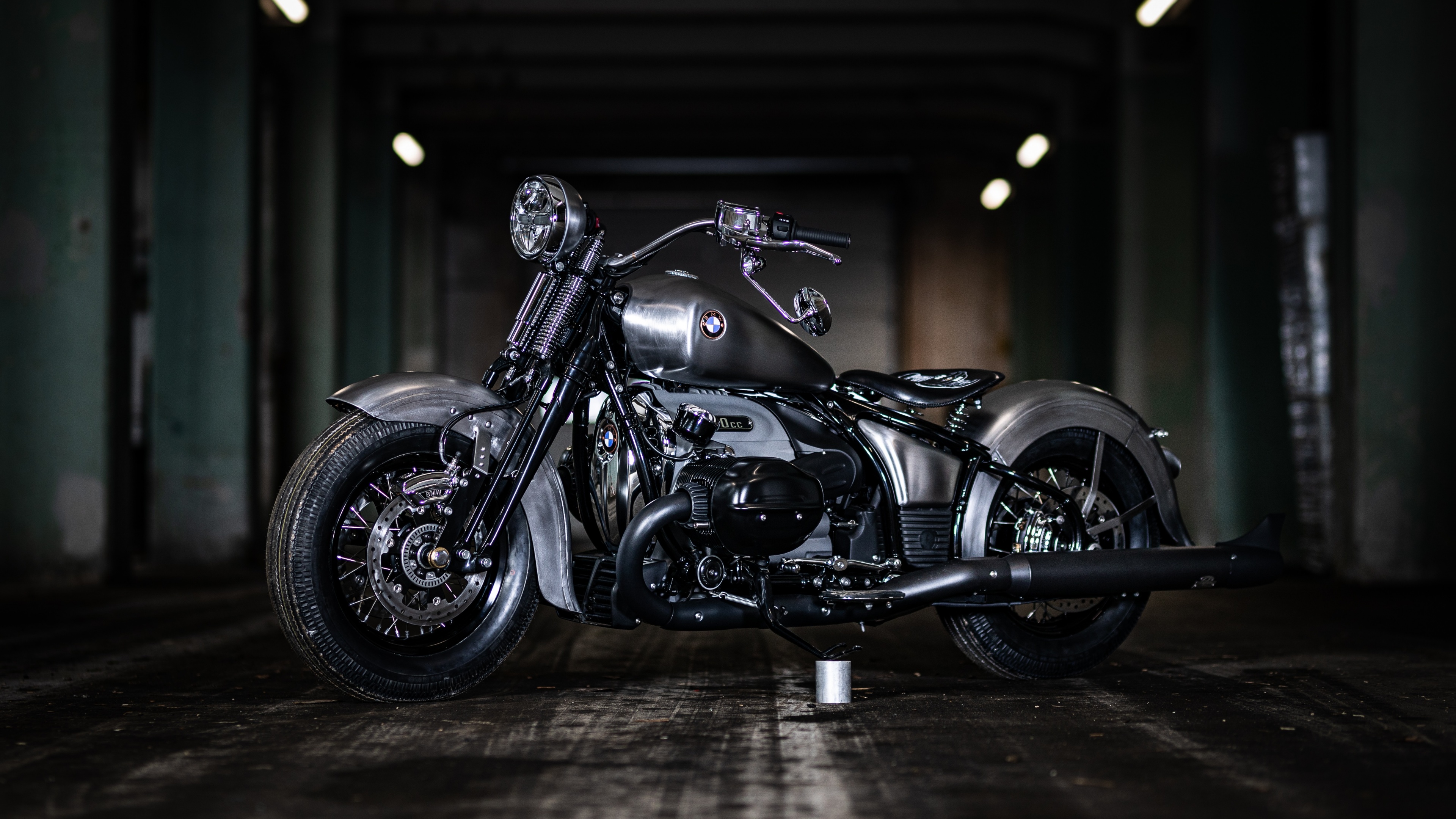 A sleek, all-black BMW R 18 custom cruiser motorcycle with premium detailing.