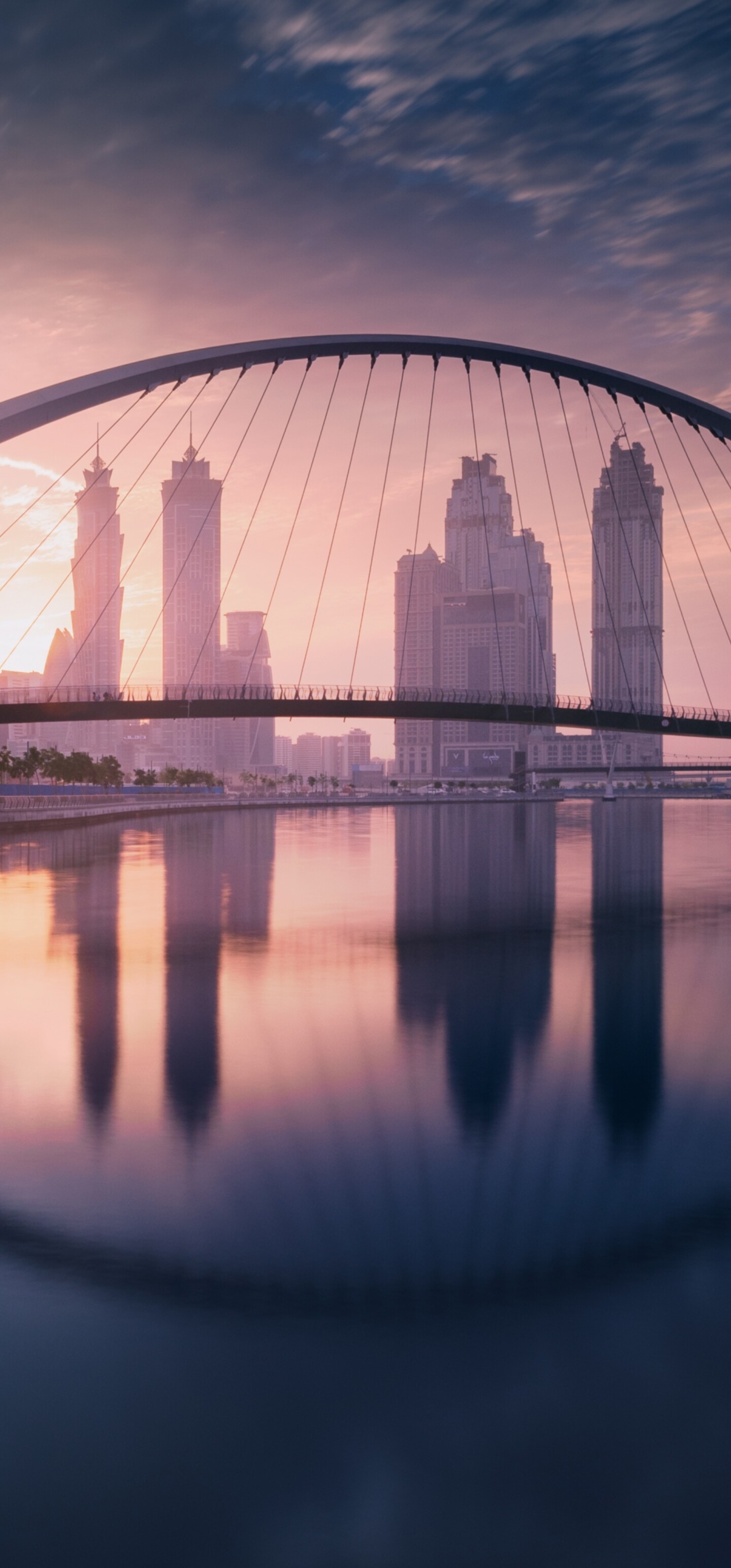 A breathtaking sunset view of the Dubai skyline featuring modern skyscrapers and waterfront architecture.