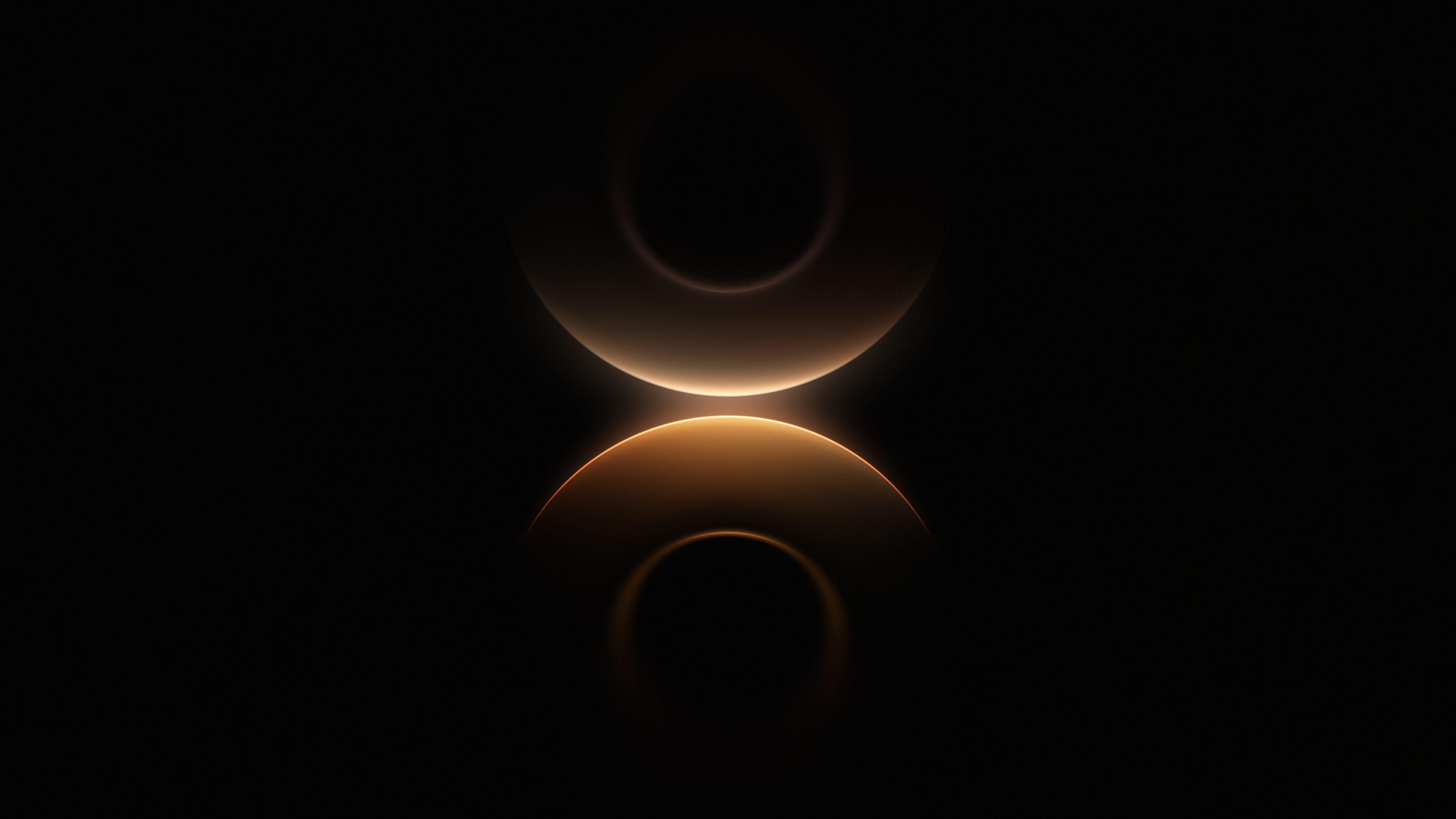 Symmetrical glowing golden yellow rings on a pitch-black background