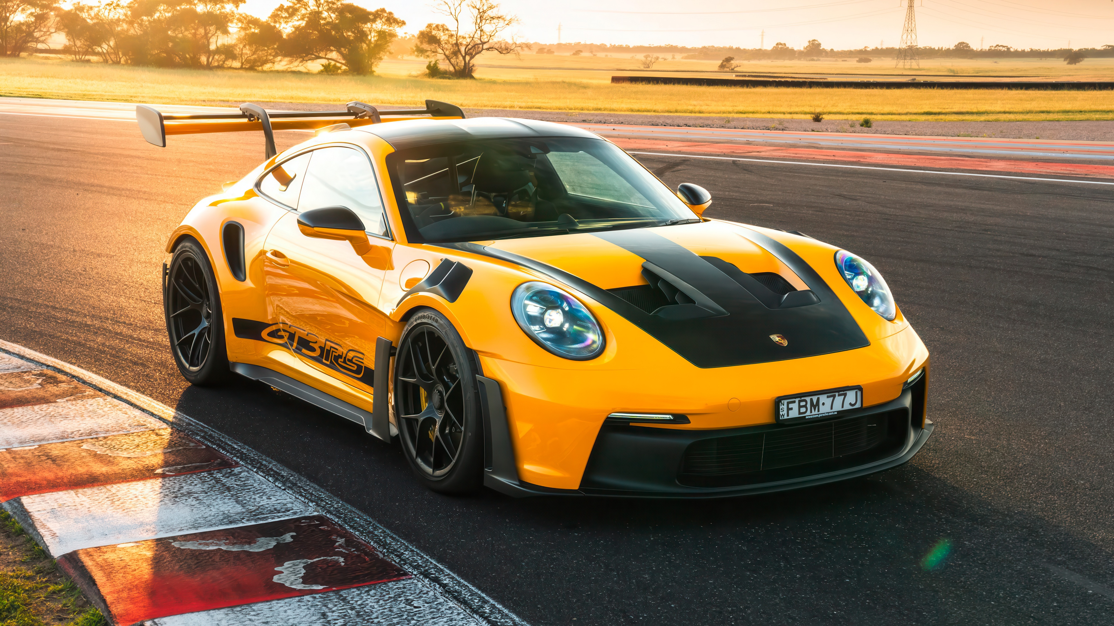 A Porsche 911 GT3 RS driving fast on a professional racing circuit