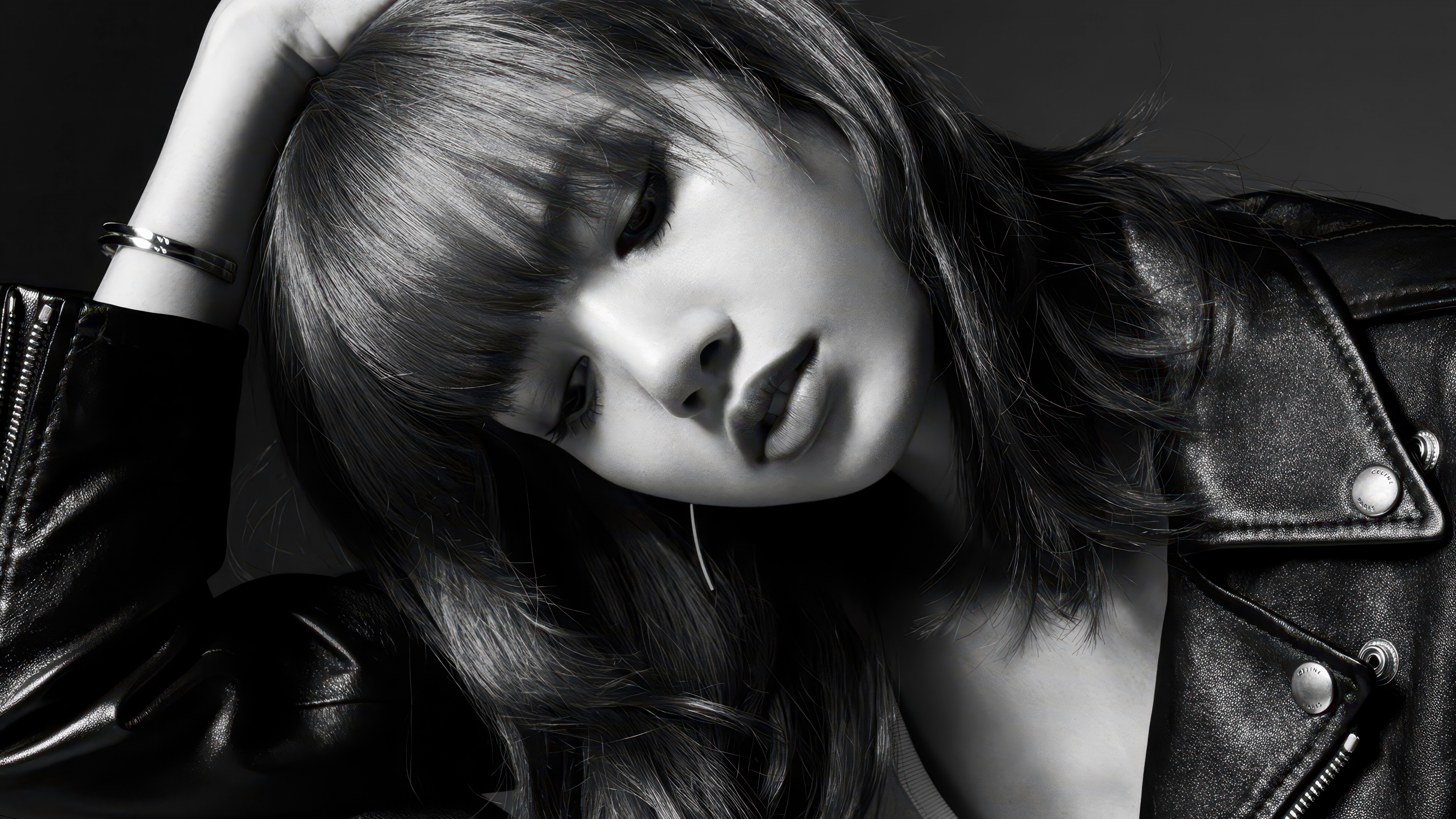 A monochrome fashion portrait of Lisa wearing a black leather jacket.