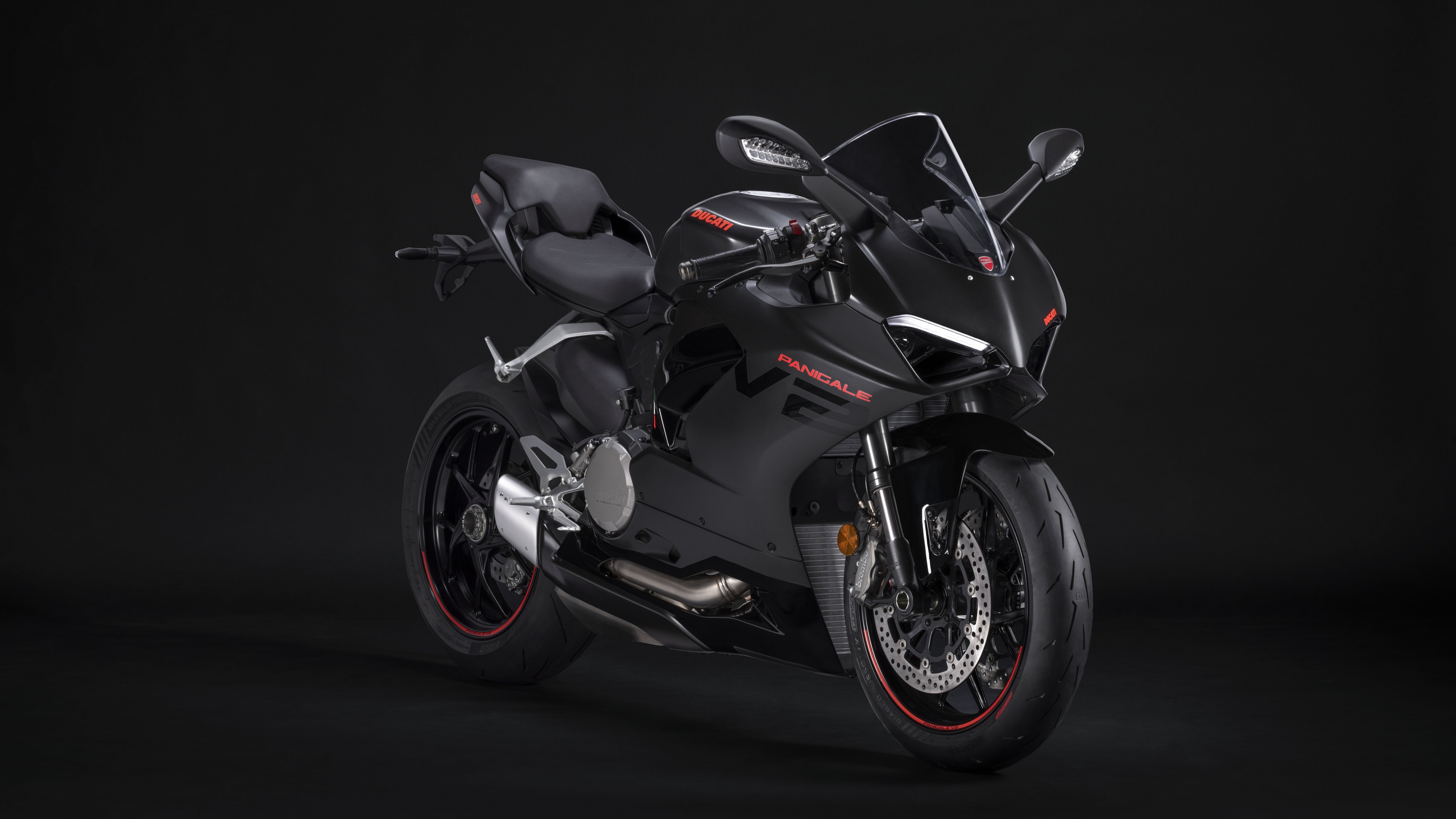 A sleek, black 2024 Ducati Panigale V2 superbike positioned against a dark, minimalist background.