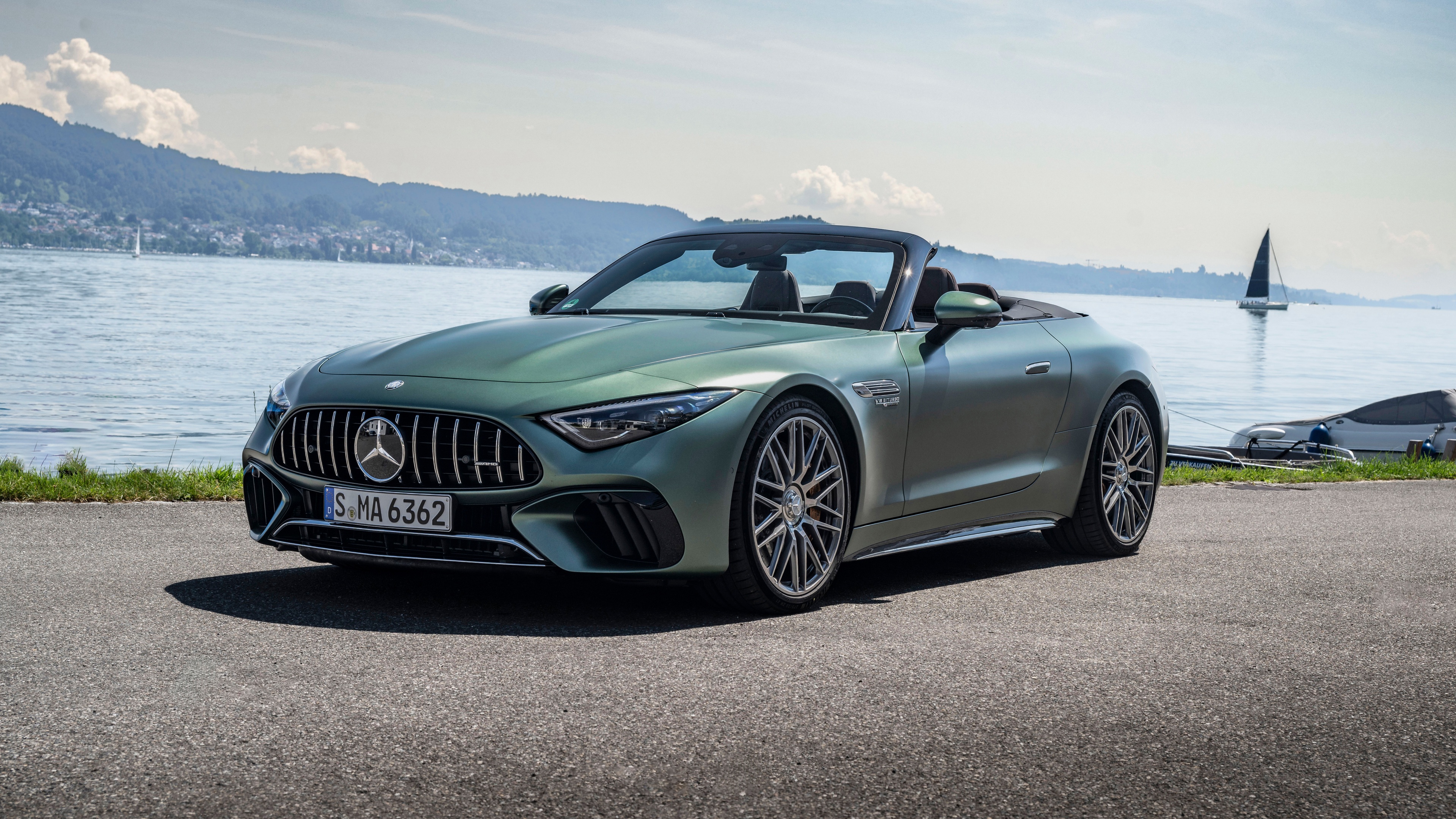 A sleek and polished 2024 Mercedes-AMG SL Roadster showcasing its aerodynamic design and metallic finish.