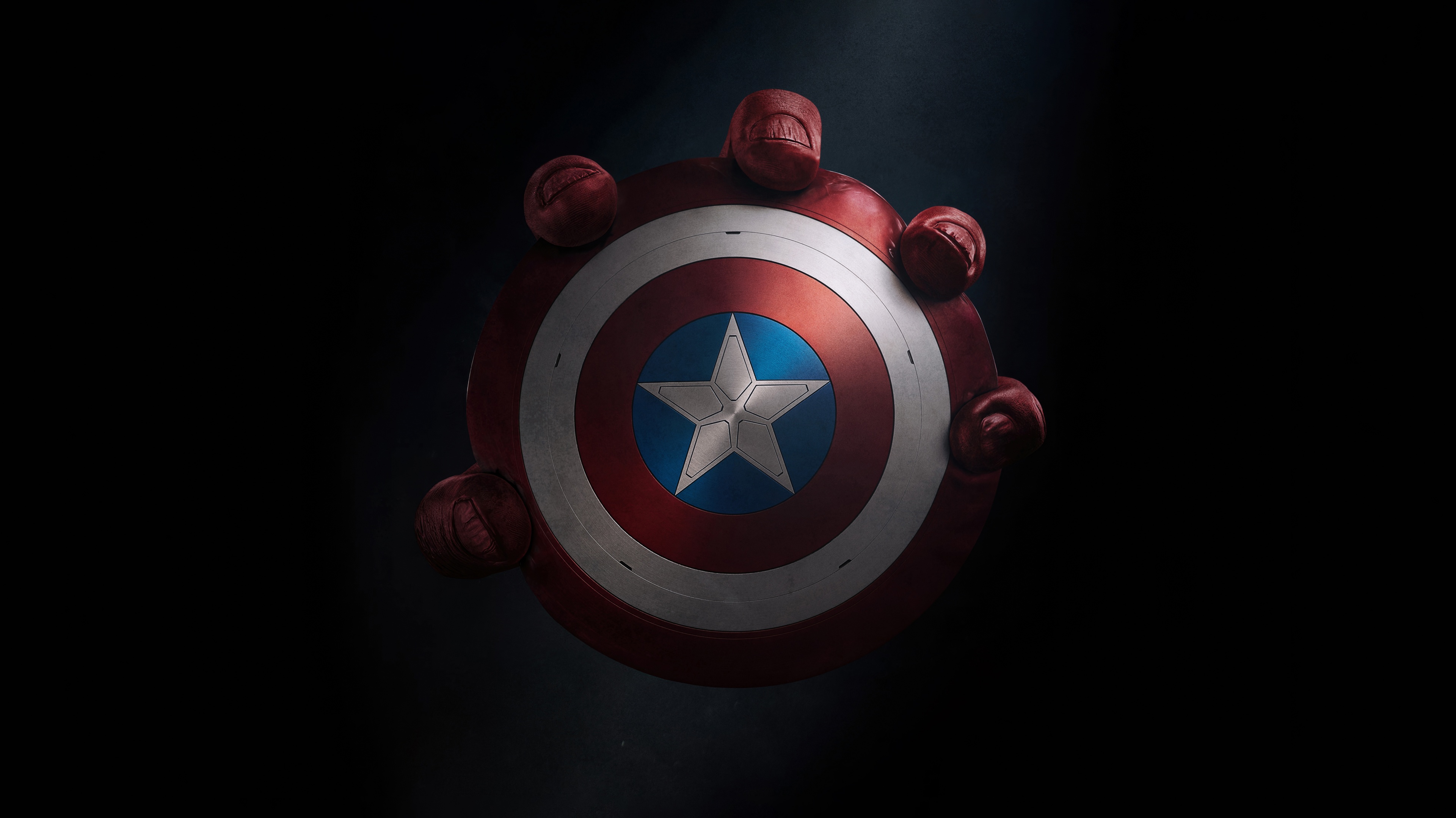 The iconic vibranium shield of Captain America prominently displayed against a dark, moody background.