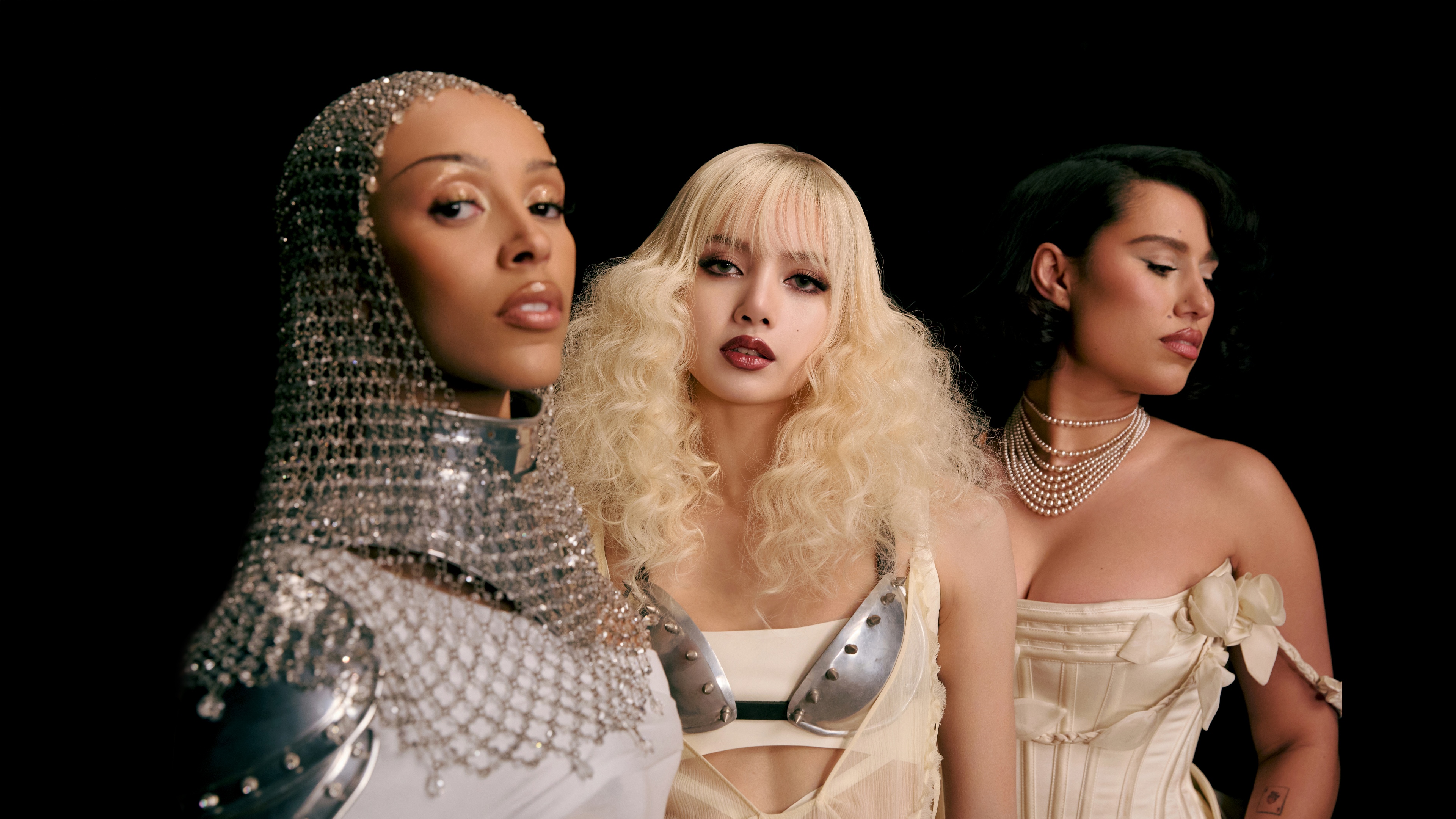 A high-resolution close-up of singers Doja Cat and Raye against a deep black background.