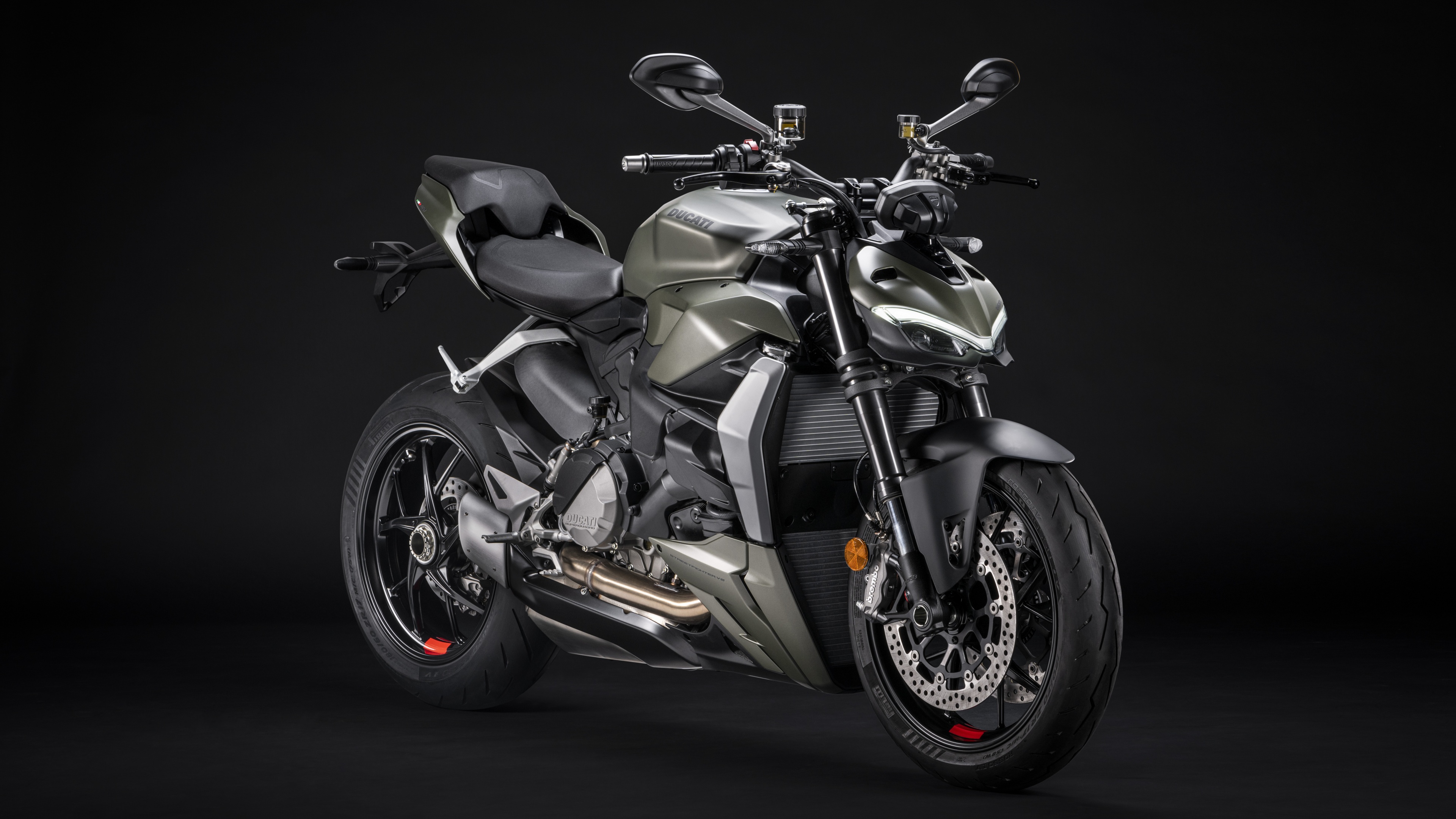 A high-detail, cinematic shot of a 2022 Ducati Streetfighter V2 sports motorcycle against a dark, atmospheric background.