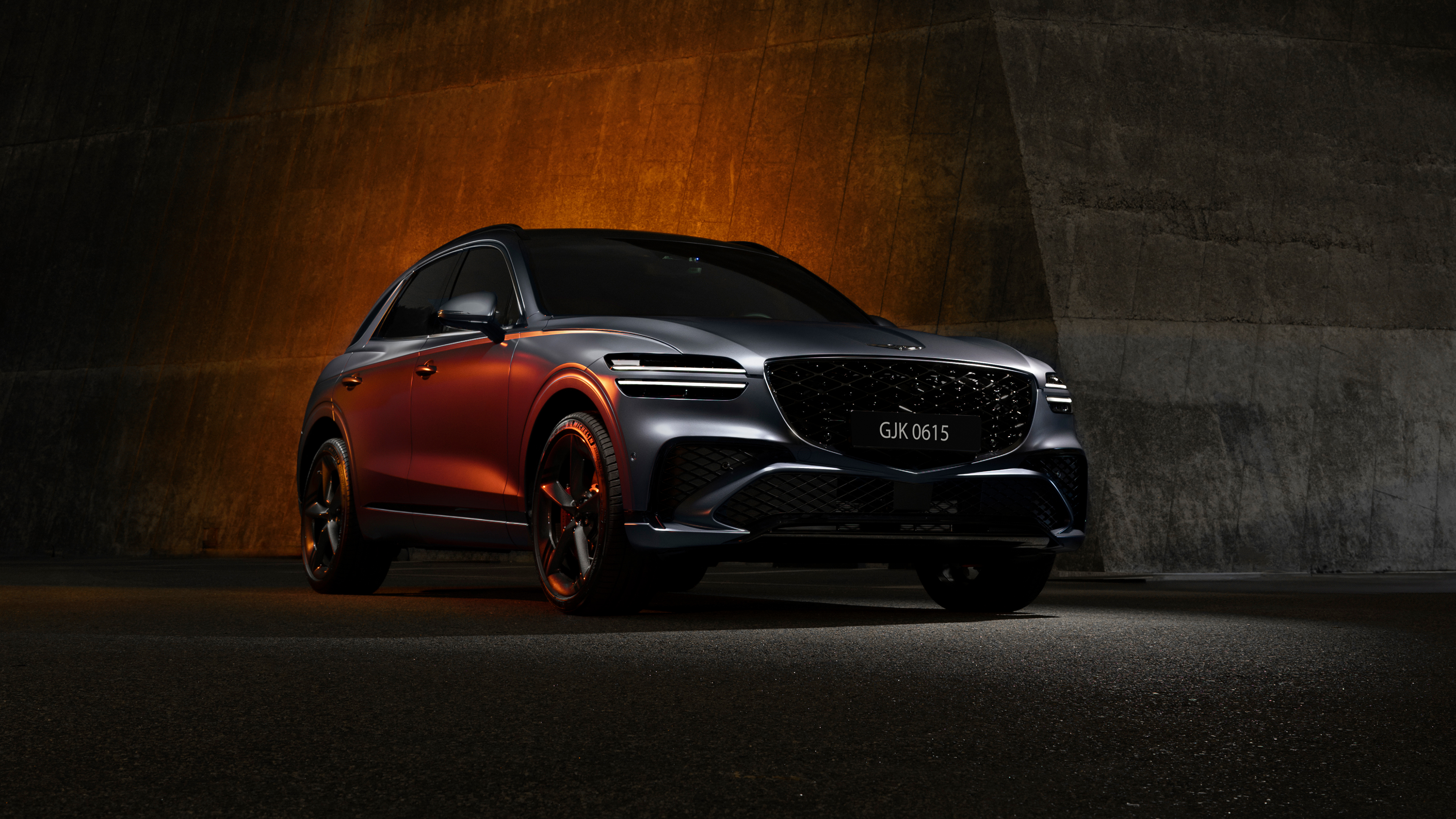 A cinematic, dark-themed shot of a 2024 Genesis GV70 luxury SUV featuring sleek lines and moody lighting.