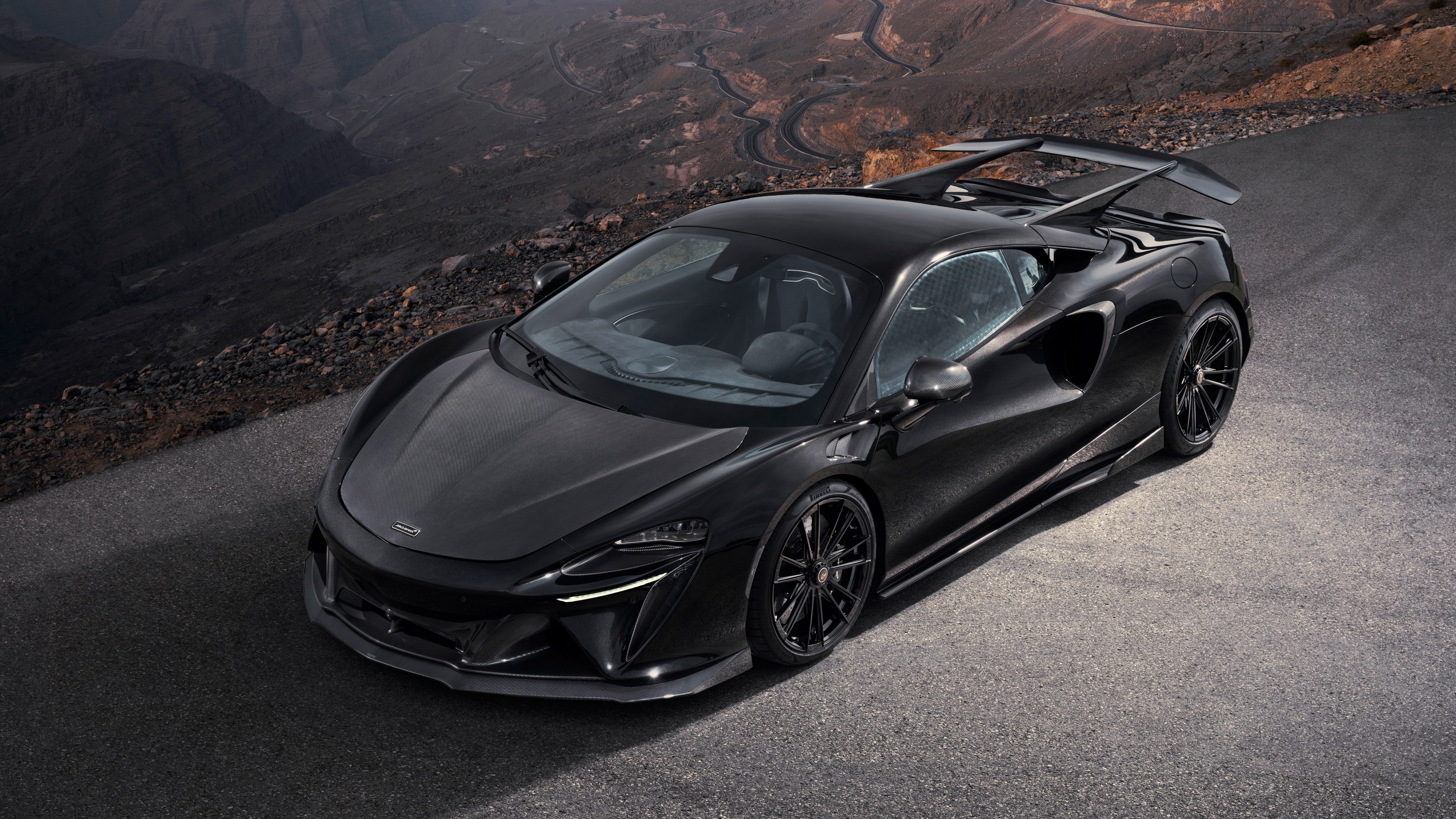 Detailed view of a 2024 Novitec McLaren Artura featuring extensive carbon fiber bodywork and aerodynamic enhancements.