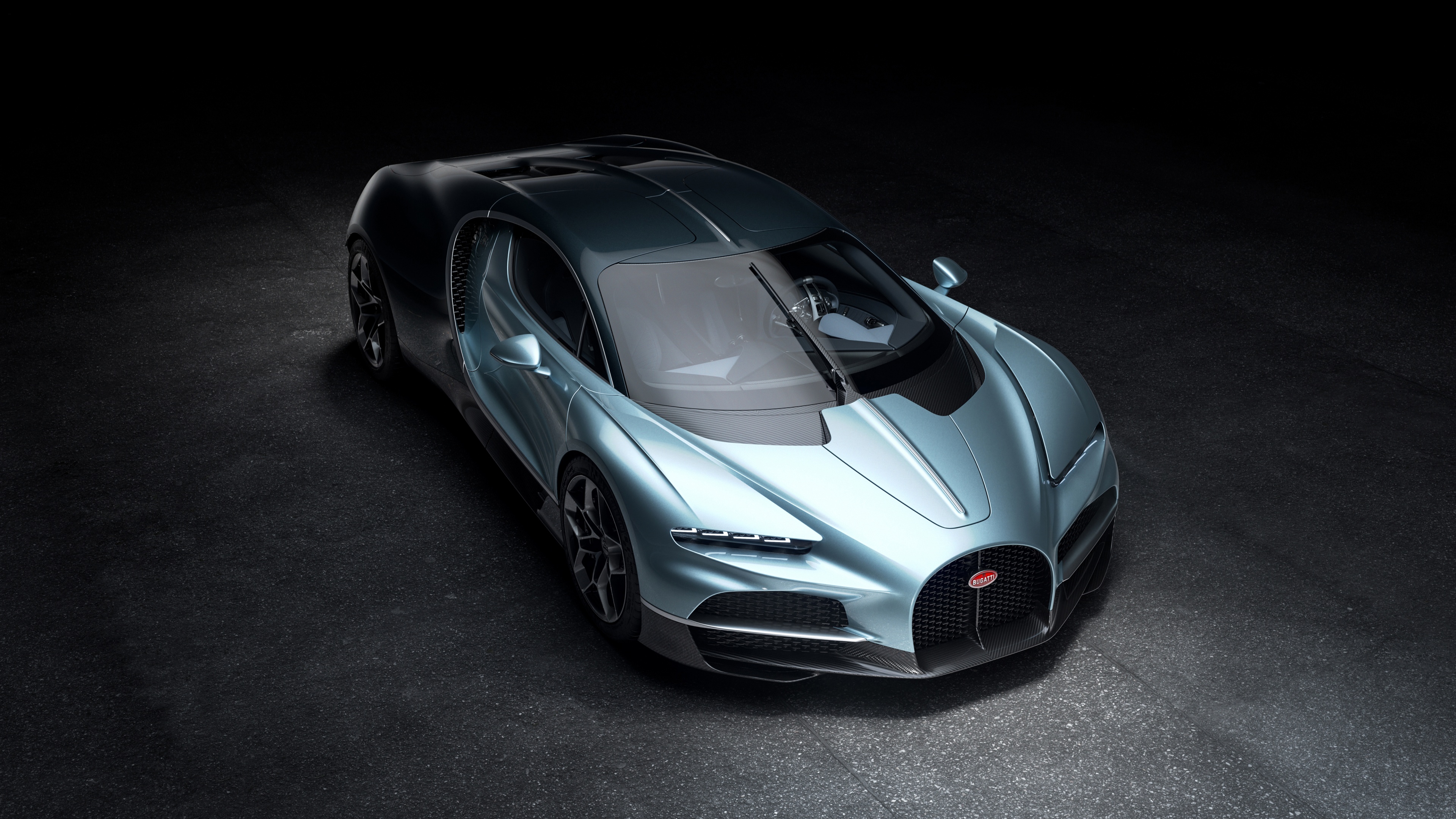 A high-resolution, cinematic shot of the 2024 Bugatti Tourbillon hypercar set against a moody, dark background.
