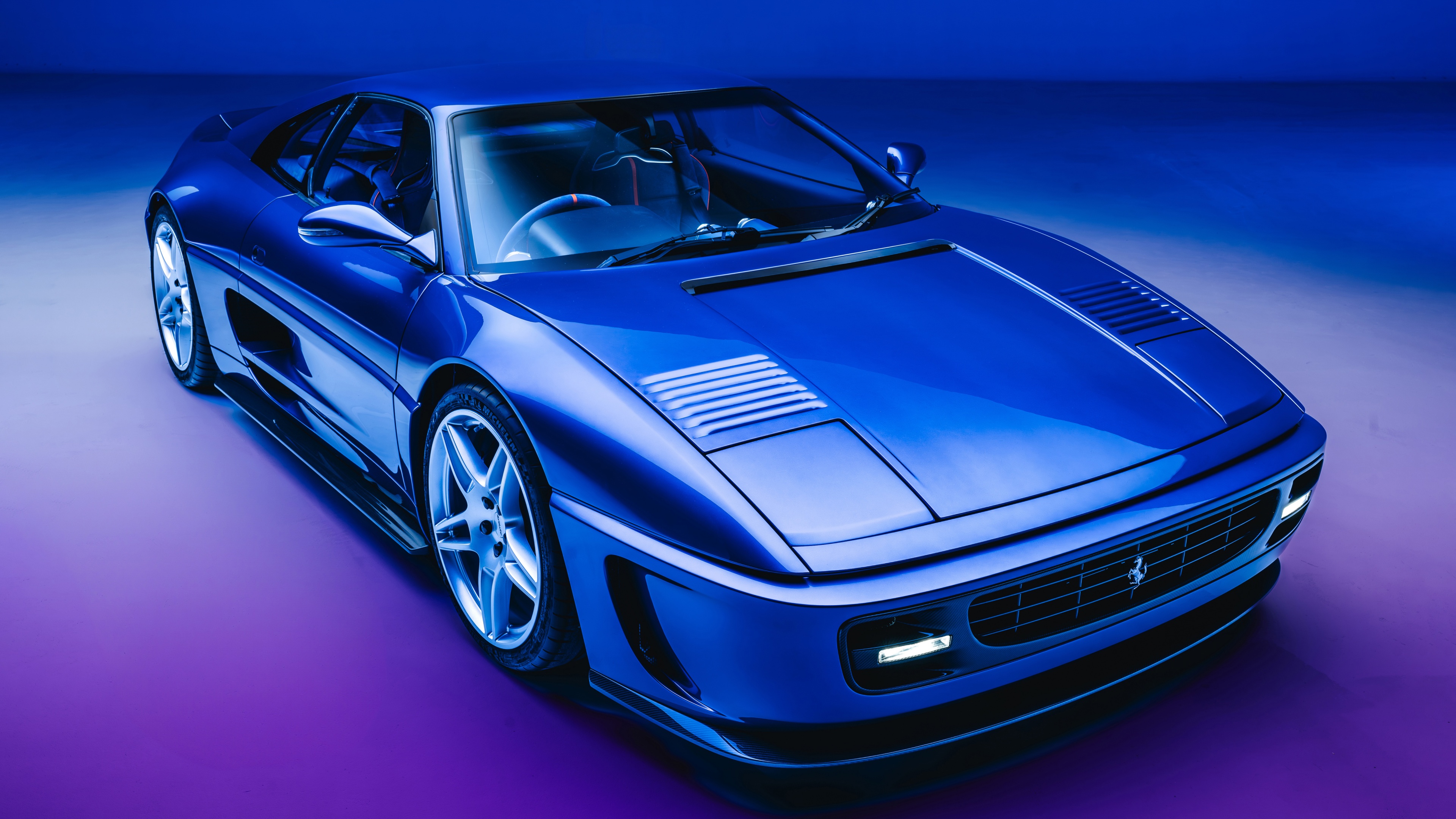 A sleek, retro-style Pininfarina concept car illuminated by neon lights in a dark, cinematic setting.