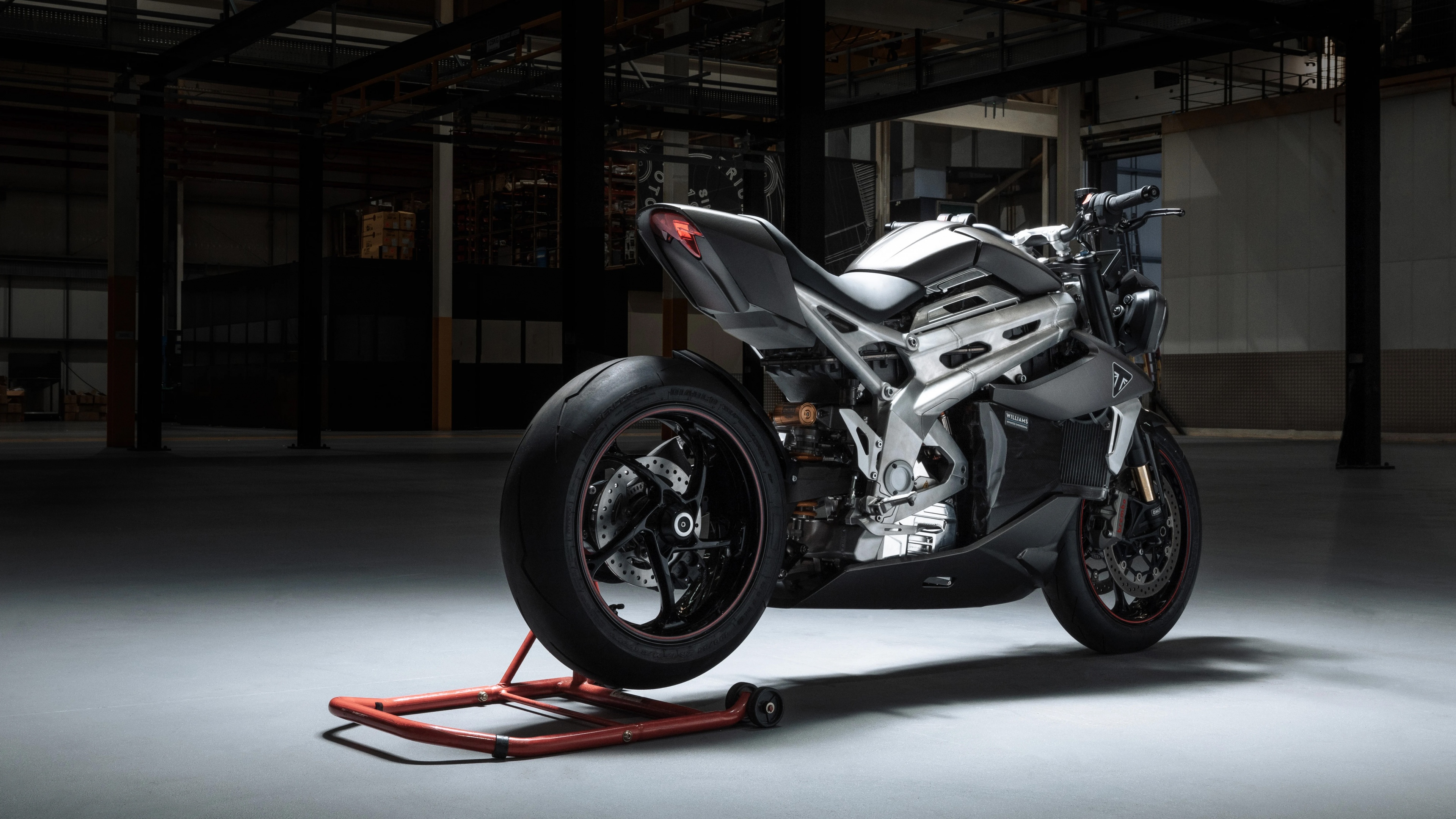 A modern and aerodynamic Triumph TE-1 electric sports motorcycle in a sleek design.